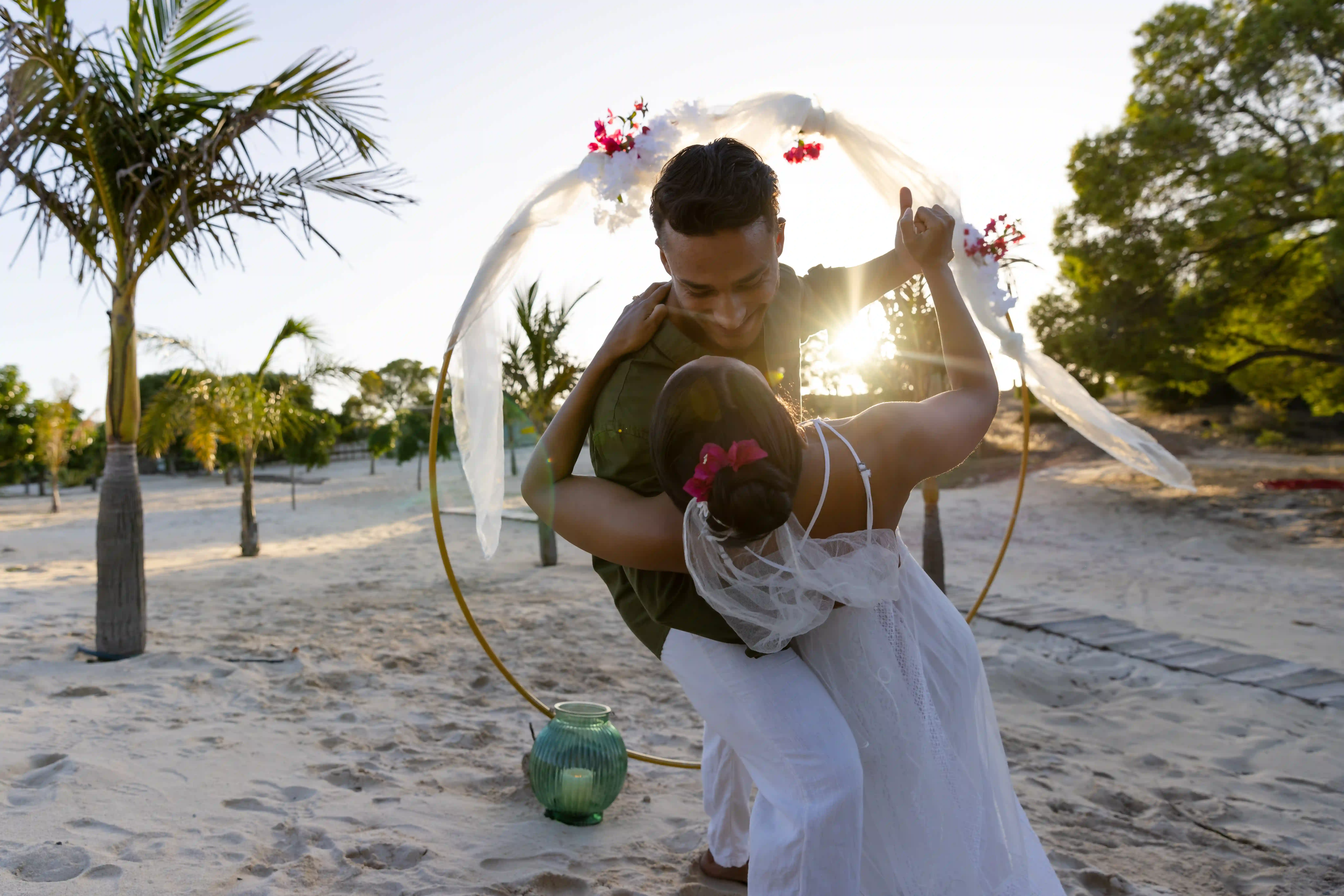 couple dancing on beach by alter