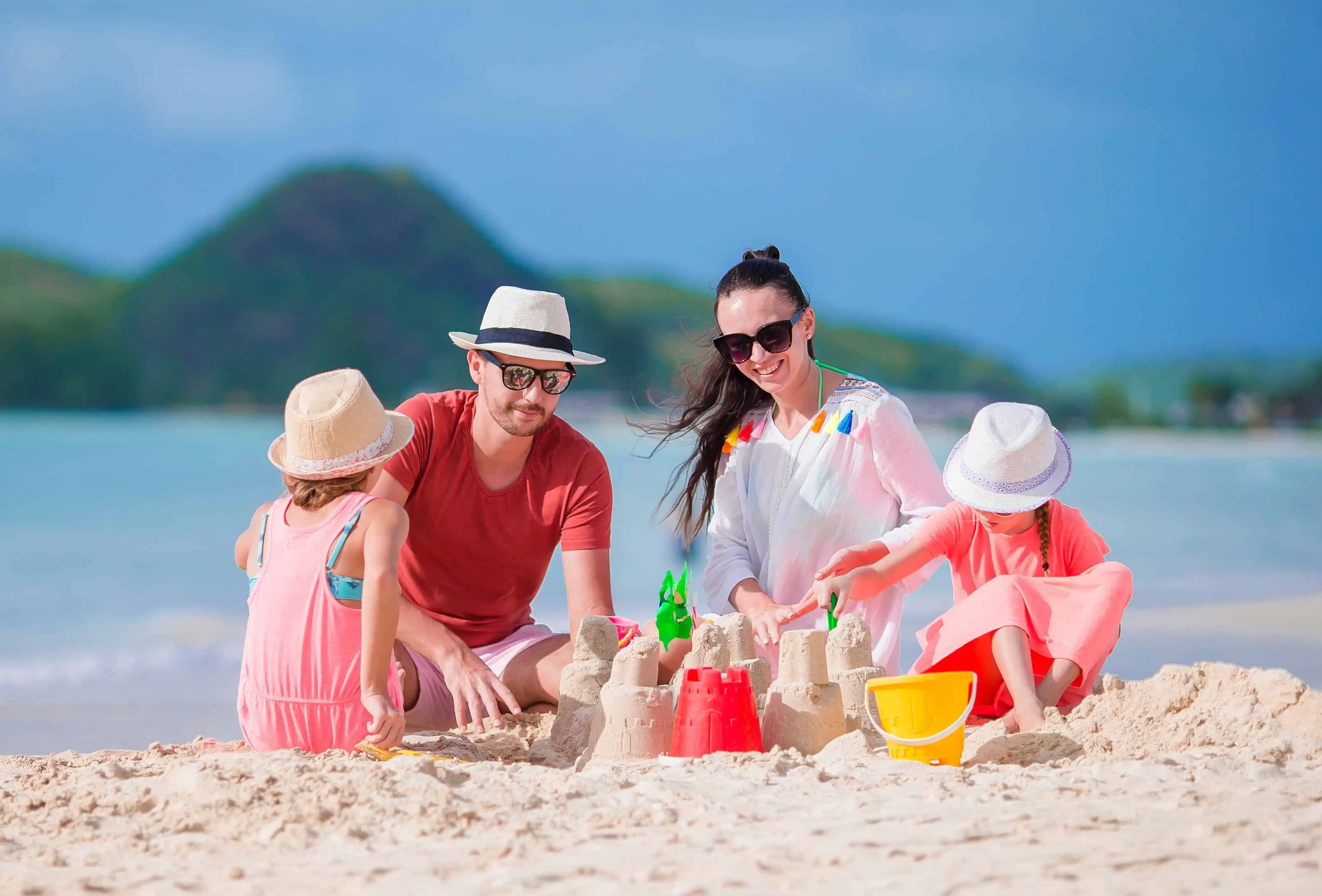 portrait of family of four on sunny beach