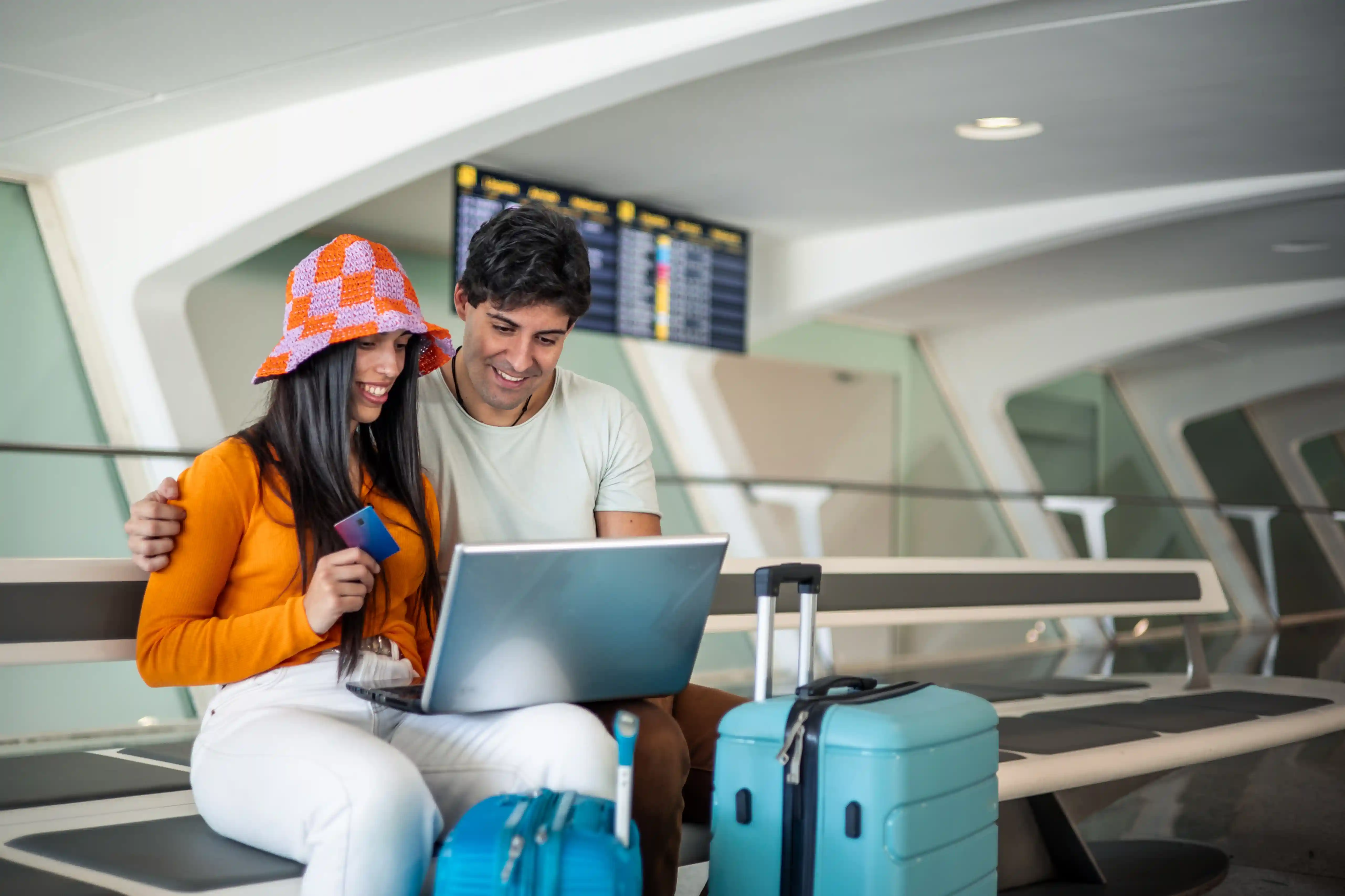 couple looking at travel insurance at airport