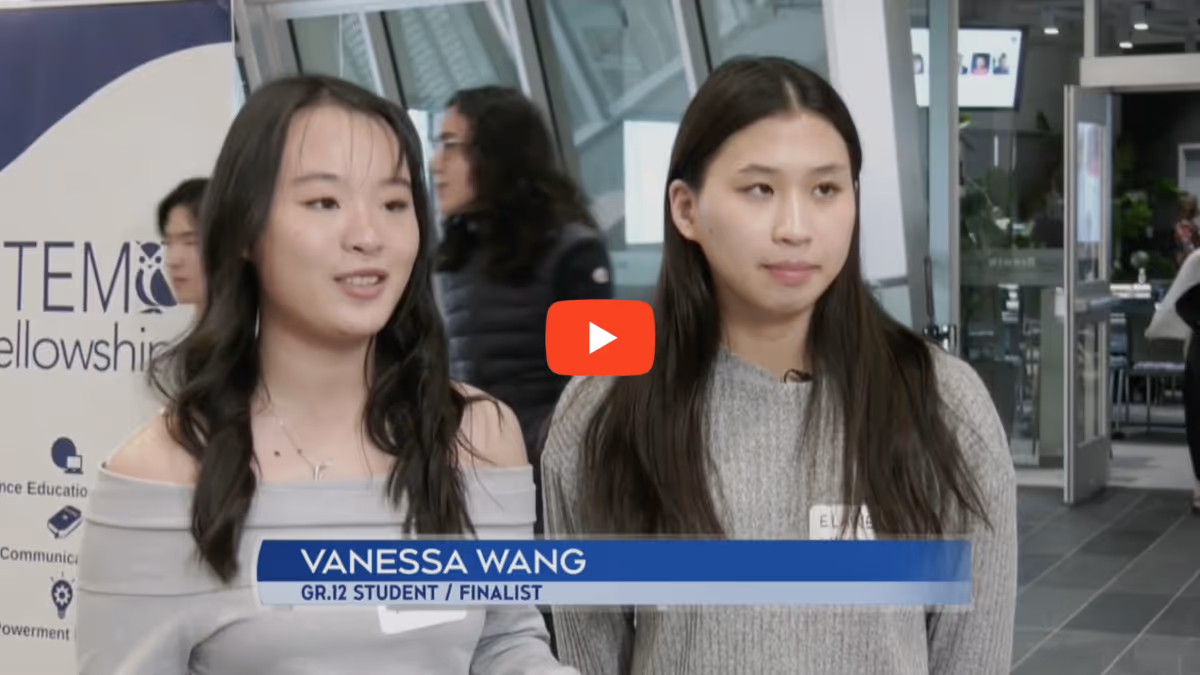 Two young women standing indoors, one identified as Vanessa Wang, Grade 12 student and finalist, speaking during an interview.