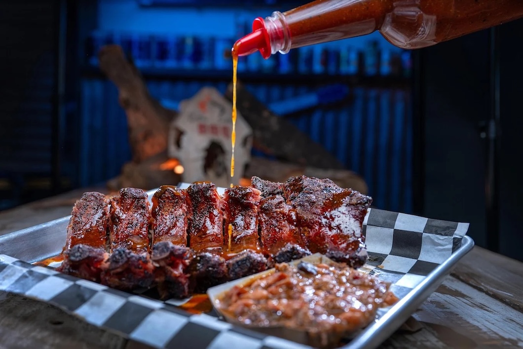 Sauce pouring on bbq ribs