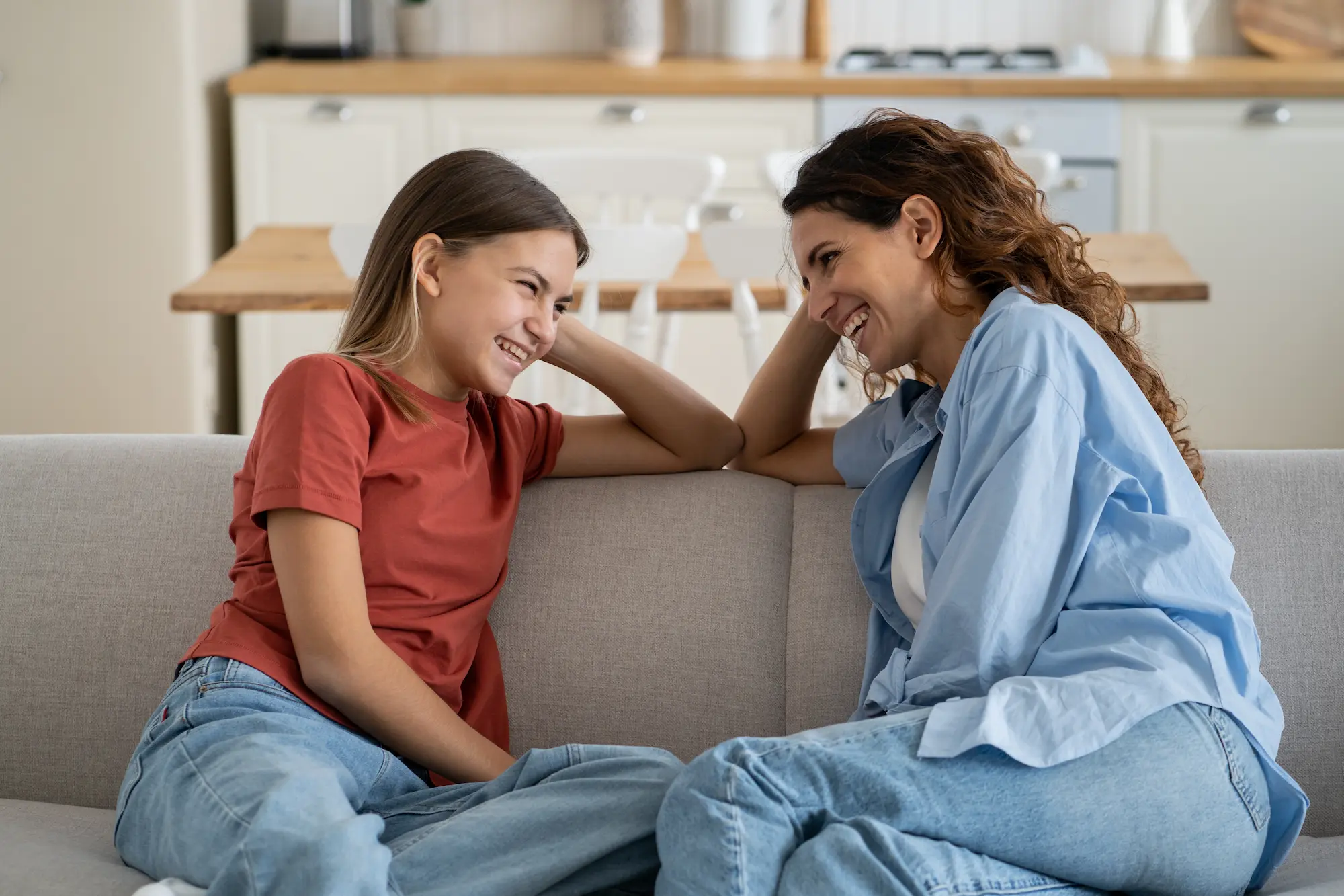 mom and dad having conversation with daughter on the couch