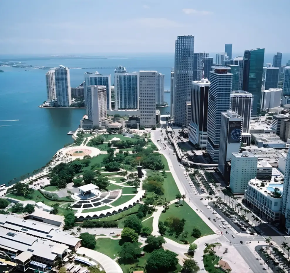 Aerial view of Miami downtown with waterfront, high-rise buildings, and green park areas.