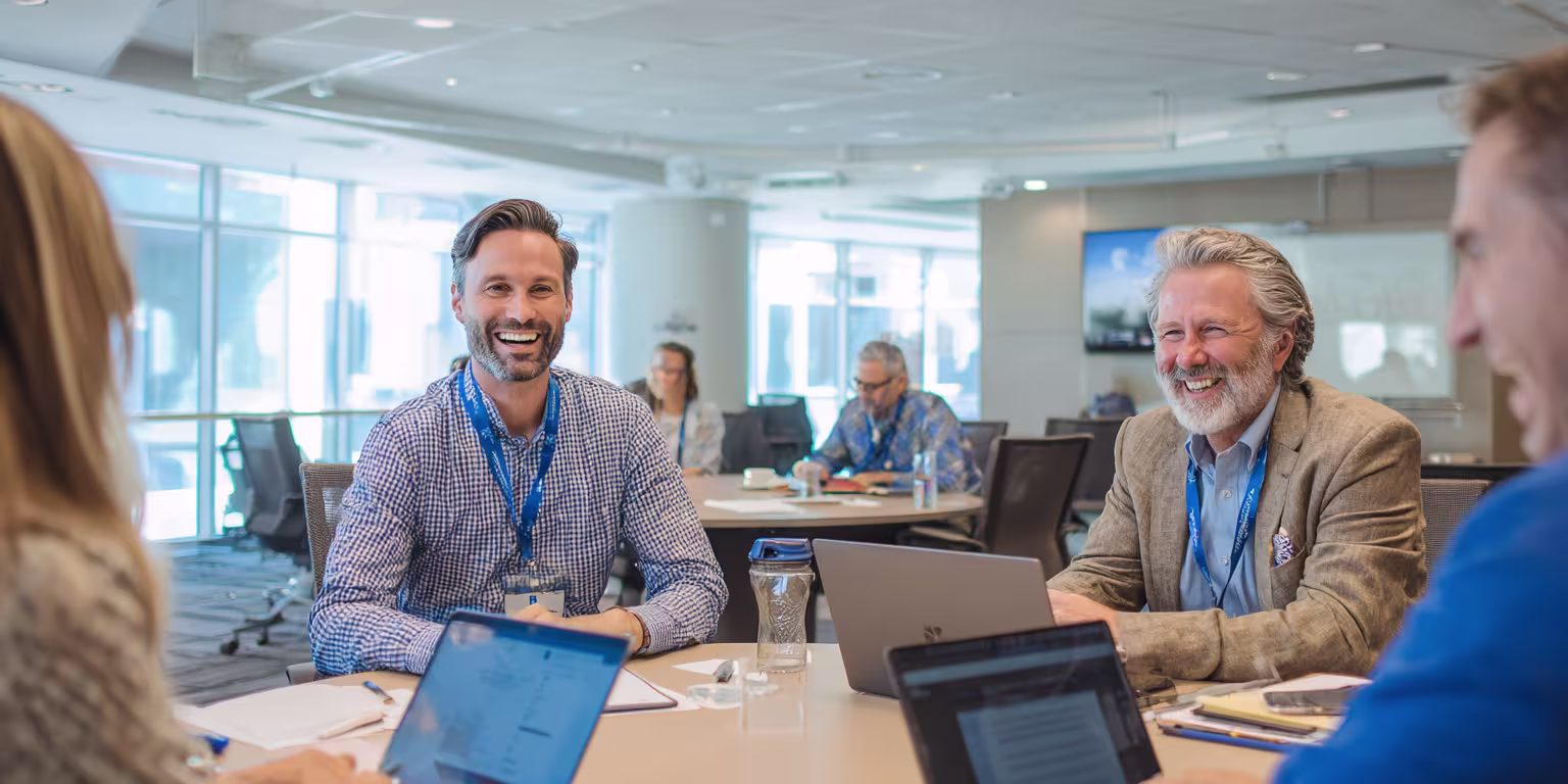 Business leadership team comparing managed IT service providers, cybersecurity capabilities, and support agreements