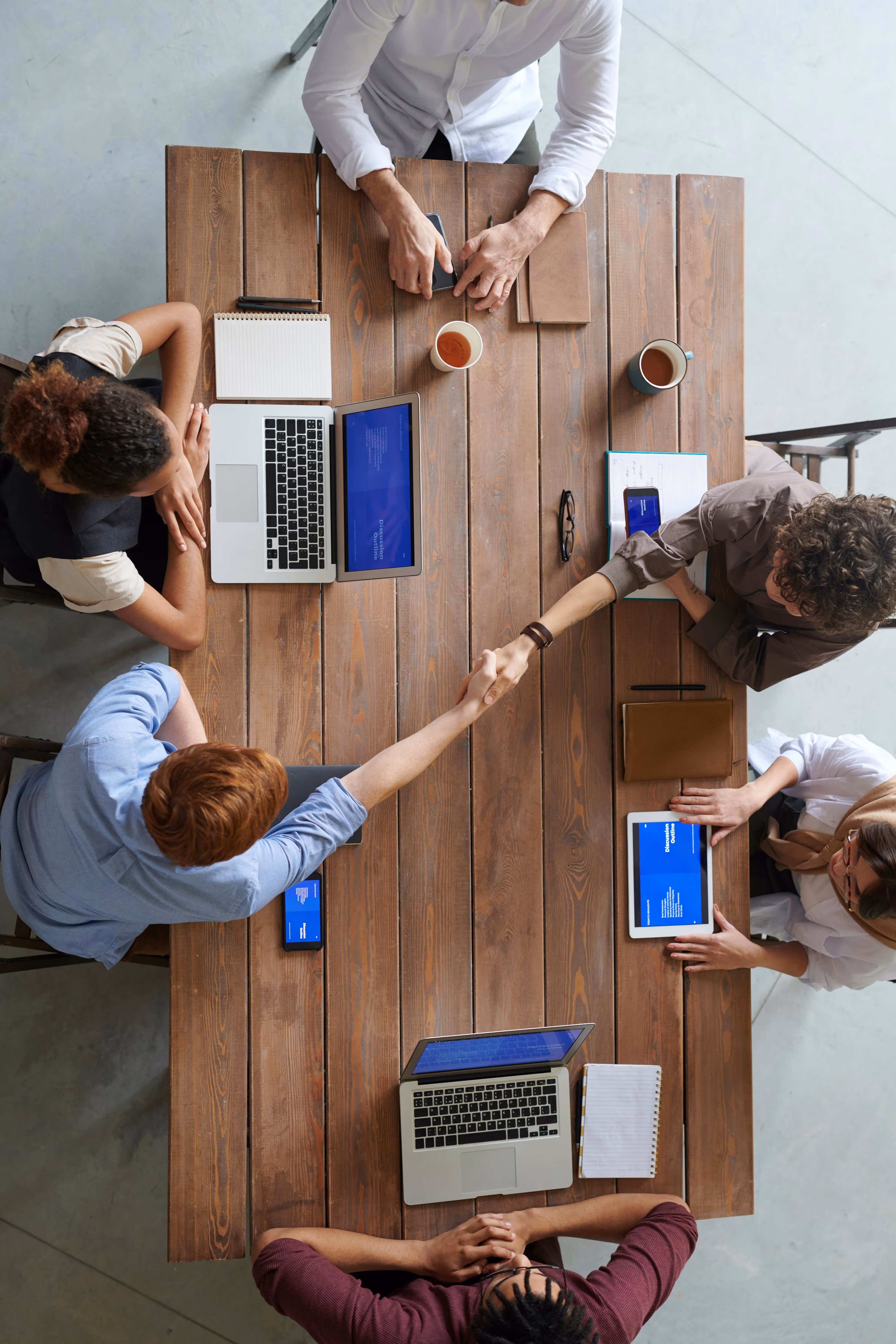 Overhead shot of a team working on a co-working table.