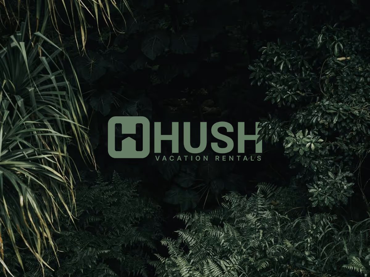 The "HHUSH VACATION RENTALS" logo, in a light green color, is centered against a dark, lush background of various green plants and foliage, creating a natural, serene aesthetic.
