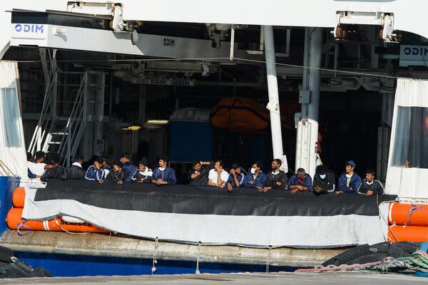Migrants who remained on the Humanity 1 rescue ship stood at the rail on Monday in the port of Catania.