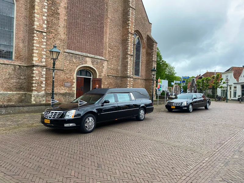Rouwstoet met begraafauto's van Begrafenisverzorging Dorst voor kerk in Stavenisse
