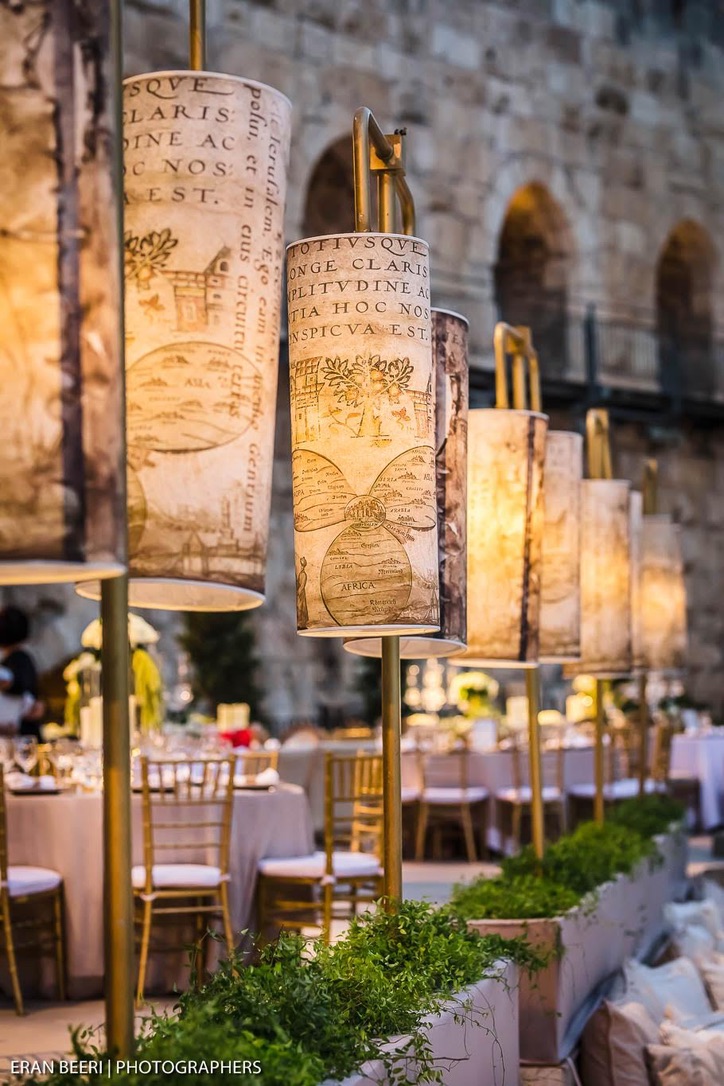 Custom printed lanterns with antique map graphics on golden poles.
