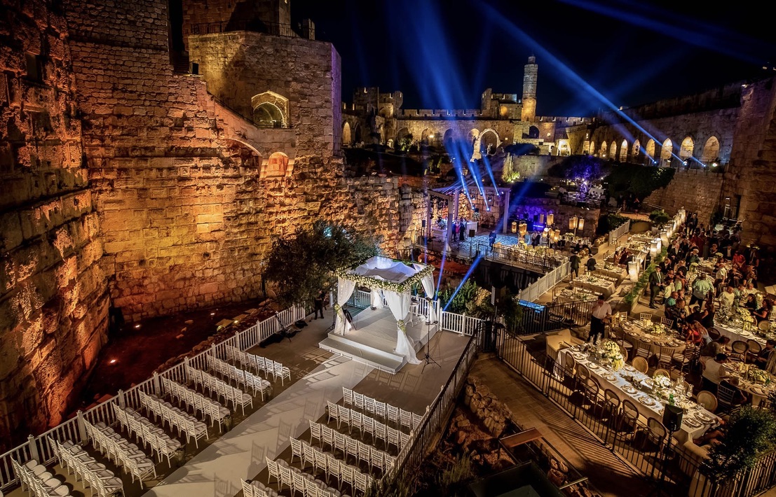 Night view of Tower of David wedding setup with chuppah and seating.