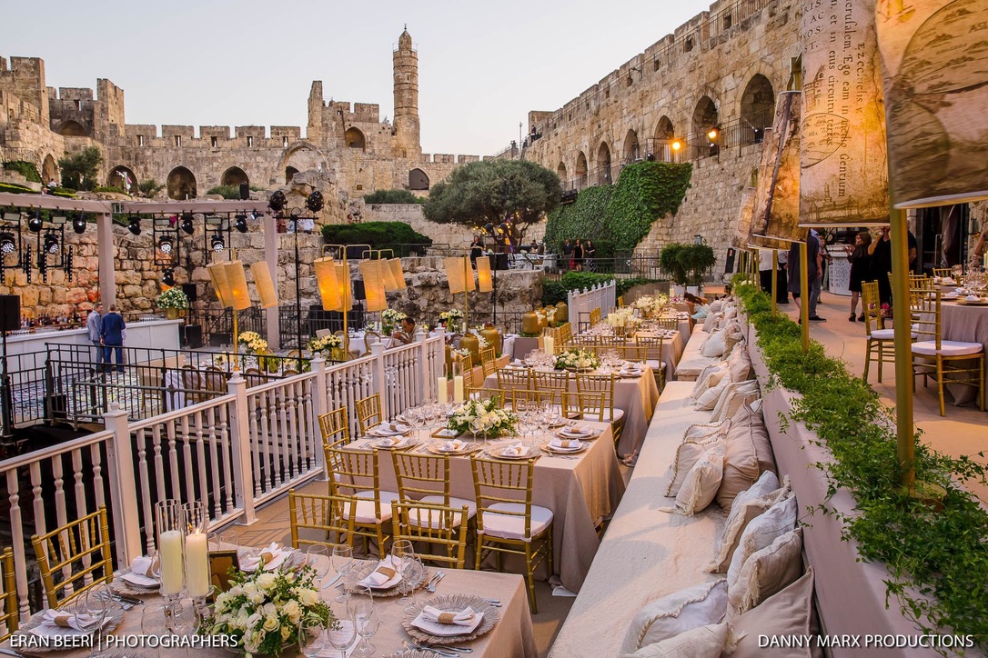 Golden hour dining area overlooking Tower of David with lanterns.