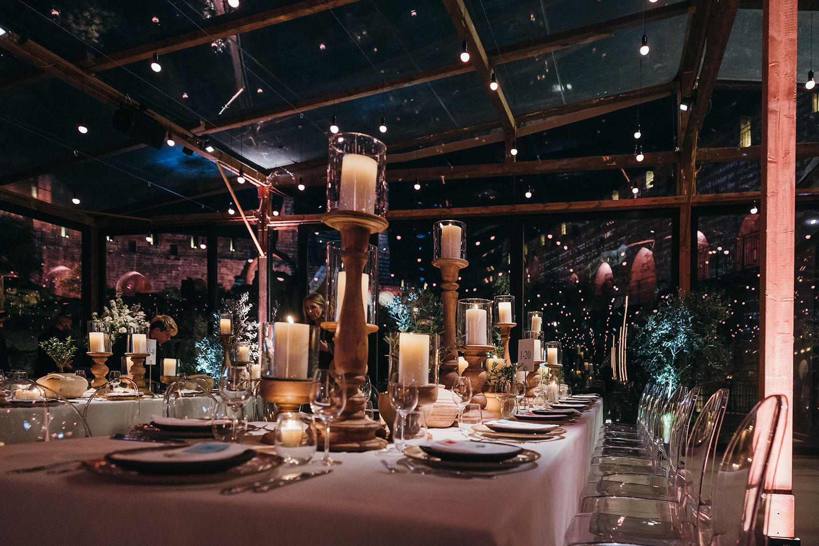 Guests mingling and enjoying the buffet inside the transparent structure of the gala event.