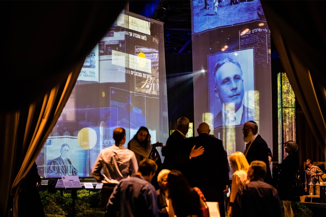 Guests viewing historical photo projections during Gav-Yam 90th anniversary celebration.