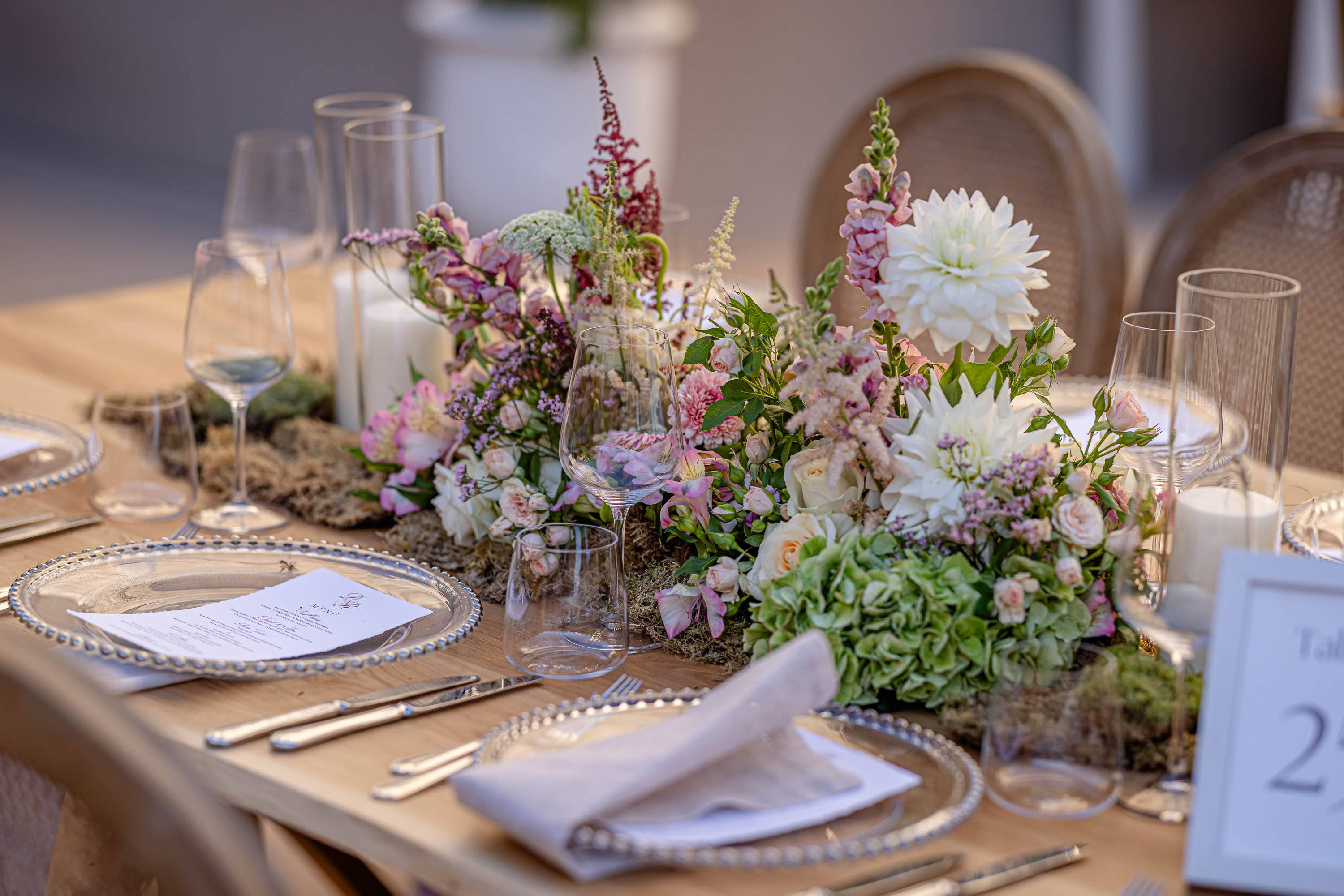 Elegant wedding table design with pink and white flowers, greenery, candles and refined place settings at the Tower of David in Jerusalem.