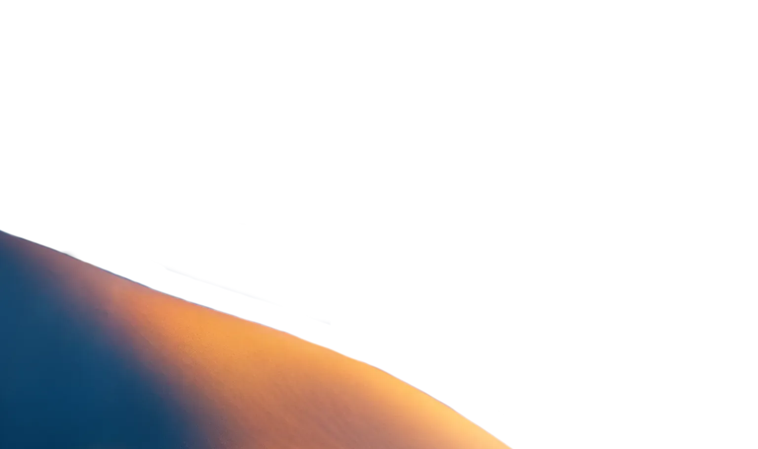 Softly shaded snowy hillside with warm light casting across the slope, creating a dreamy winter backdrop ideal for holiday-themed visual design.