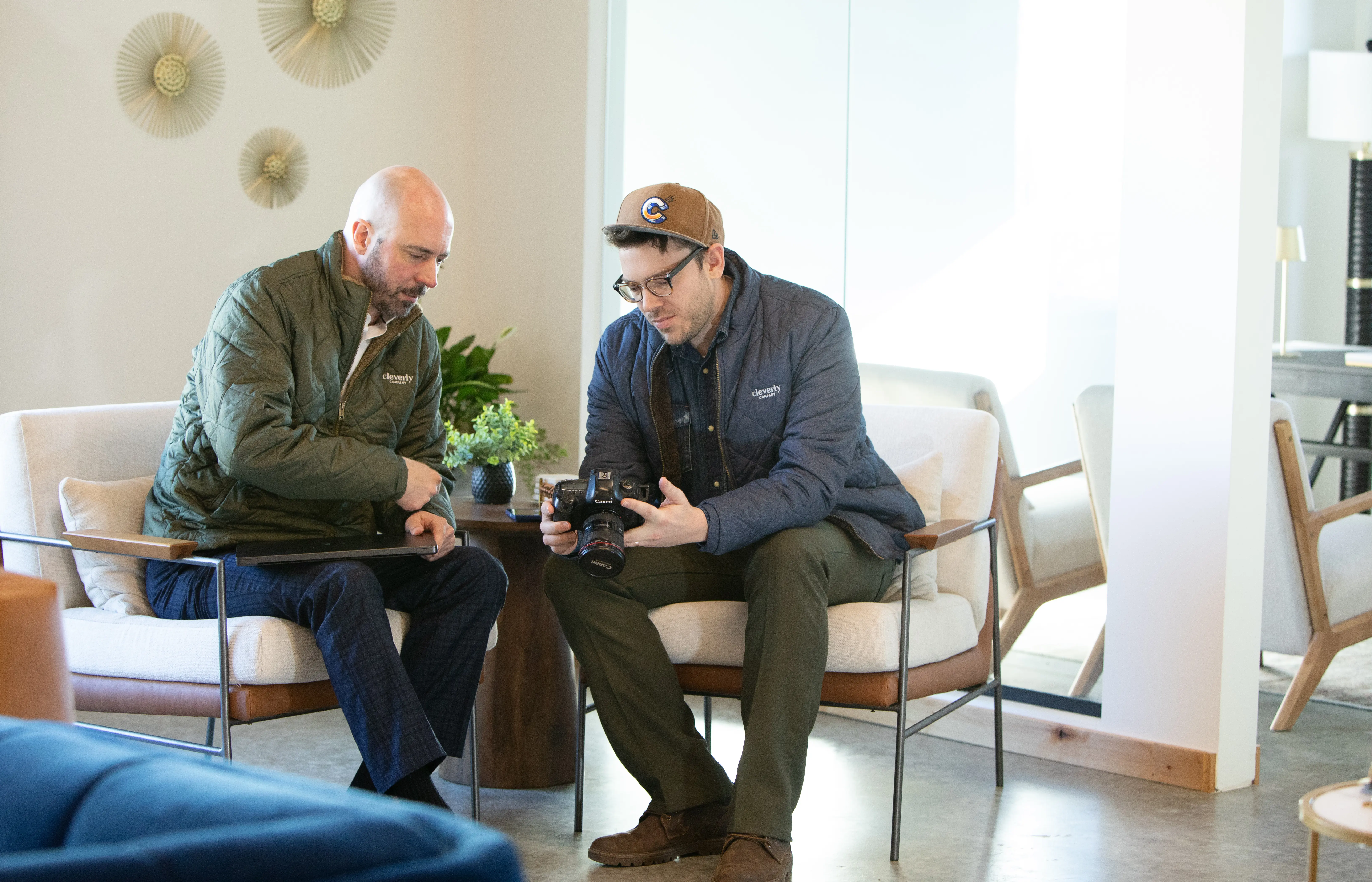 Cleverly video production team reviewing camera footage during a client shoot planning meeting.