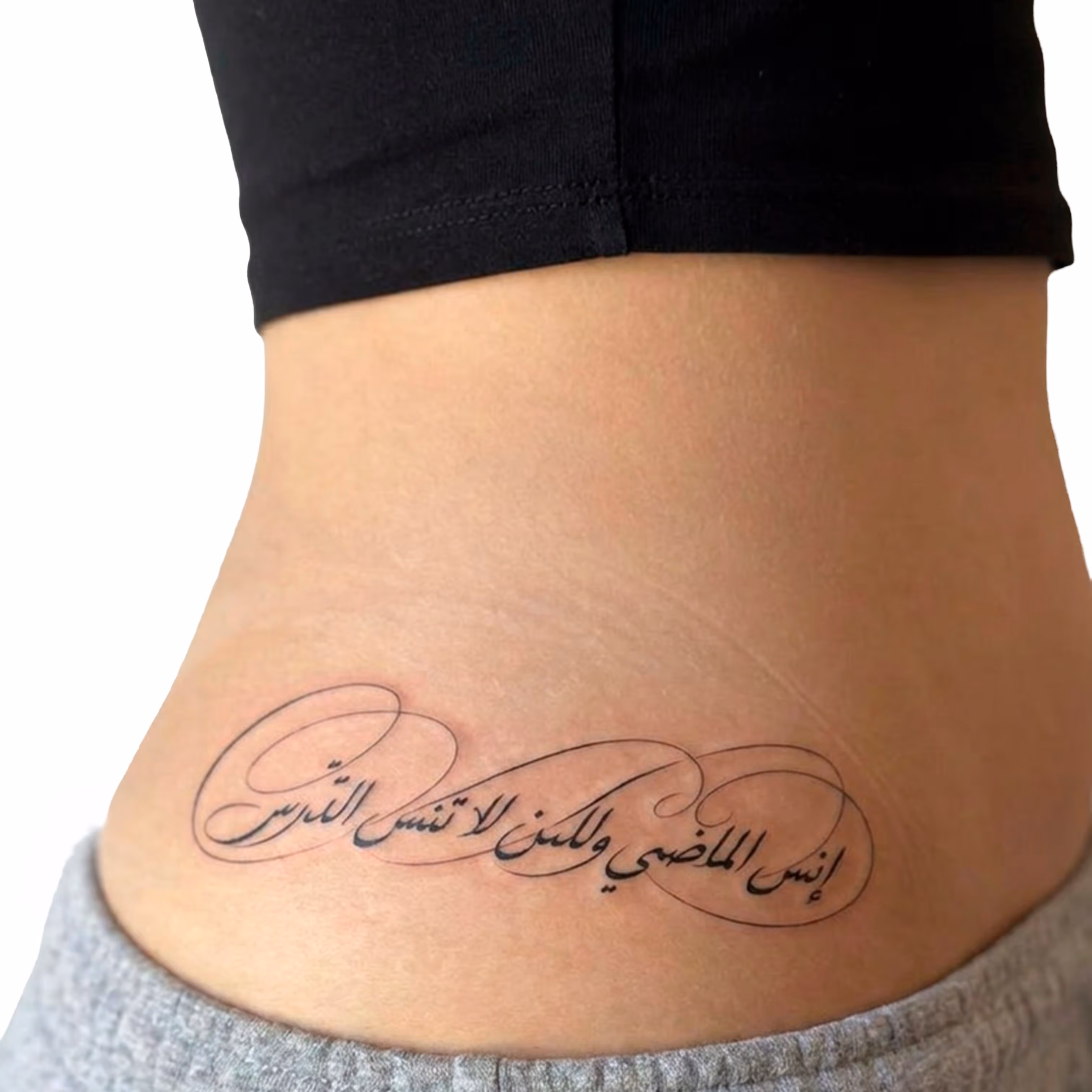 Tattoo på siden af en persons mave med elegant arabisk kalligrafi.