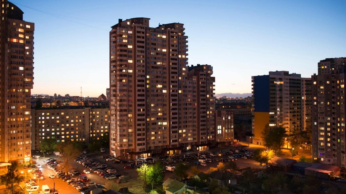 Kiev, Ukraine, skyline at dusk, showcasing illuminated buildings against a twilight sky.