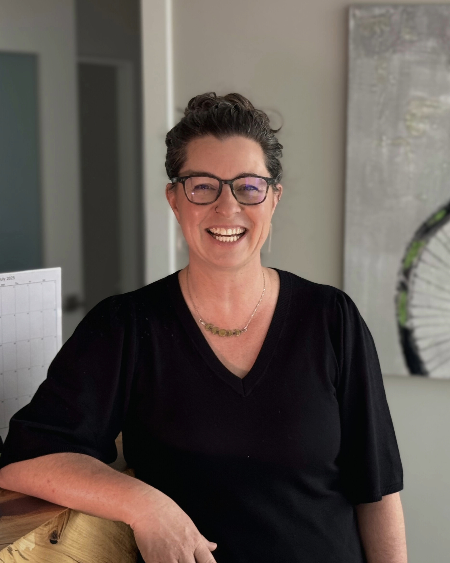 A portrait of registered massage therapist and instructor Alanna Thompson. She smiles at the camera.