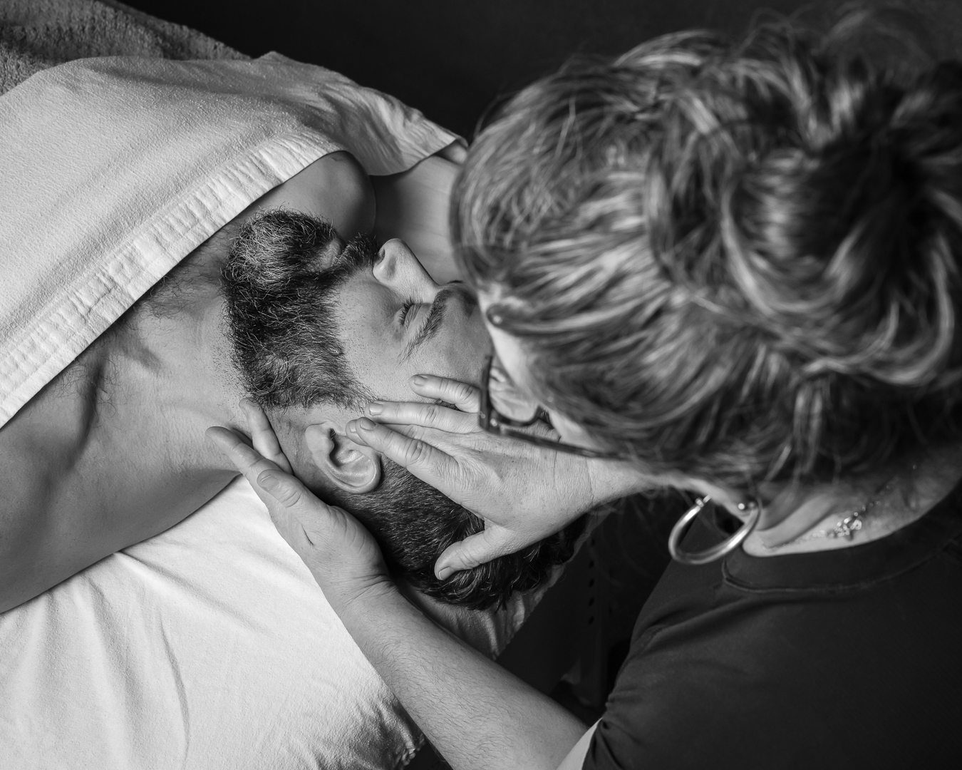 face massage of a male on a massage table