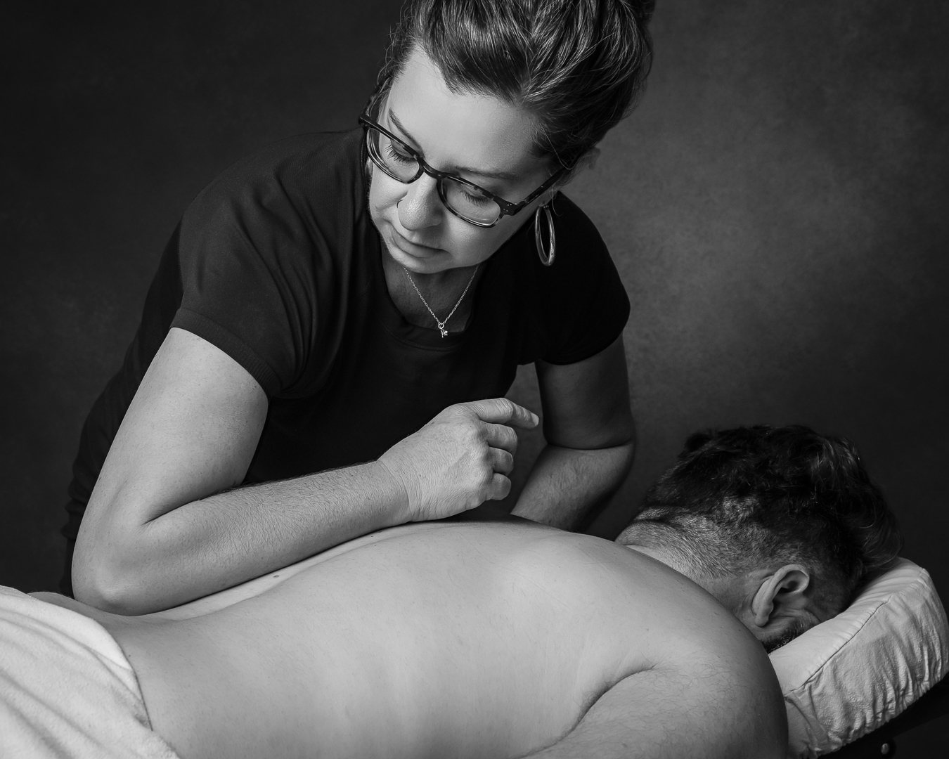 massage therapist working on a patient's back
