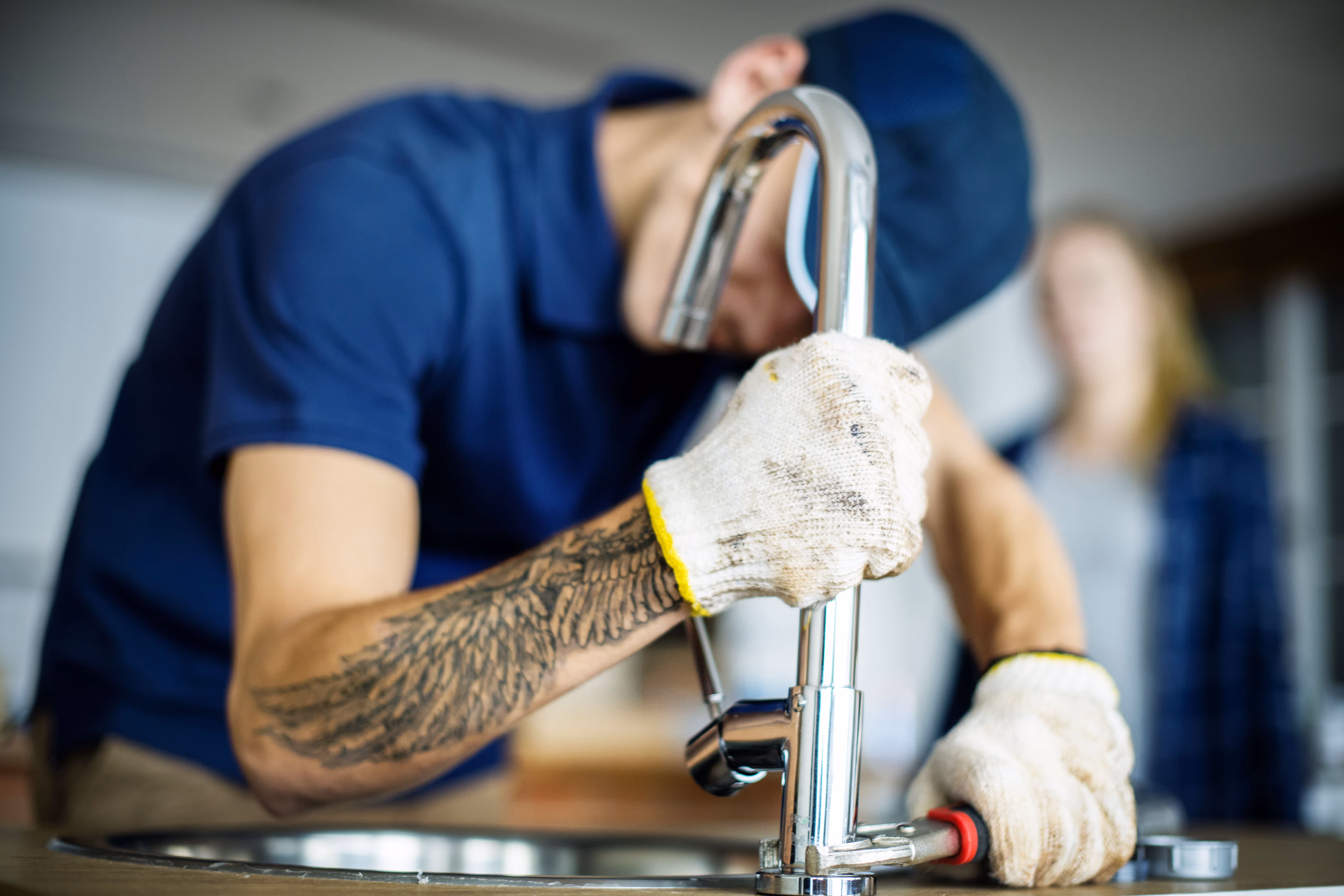 A plumber fixing a kitchen sink.
