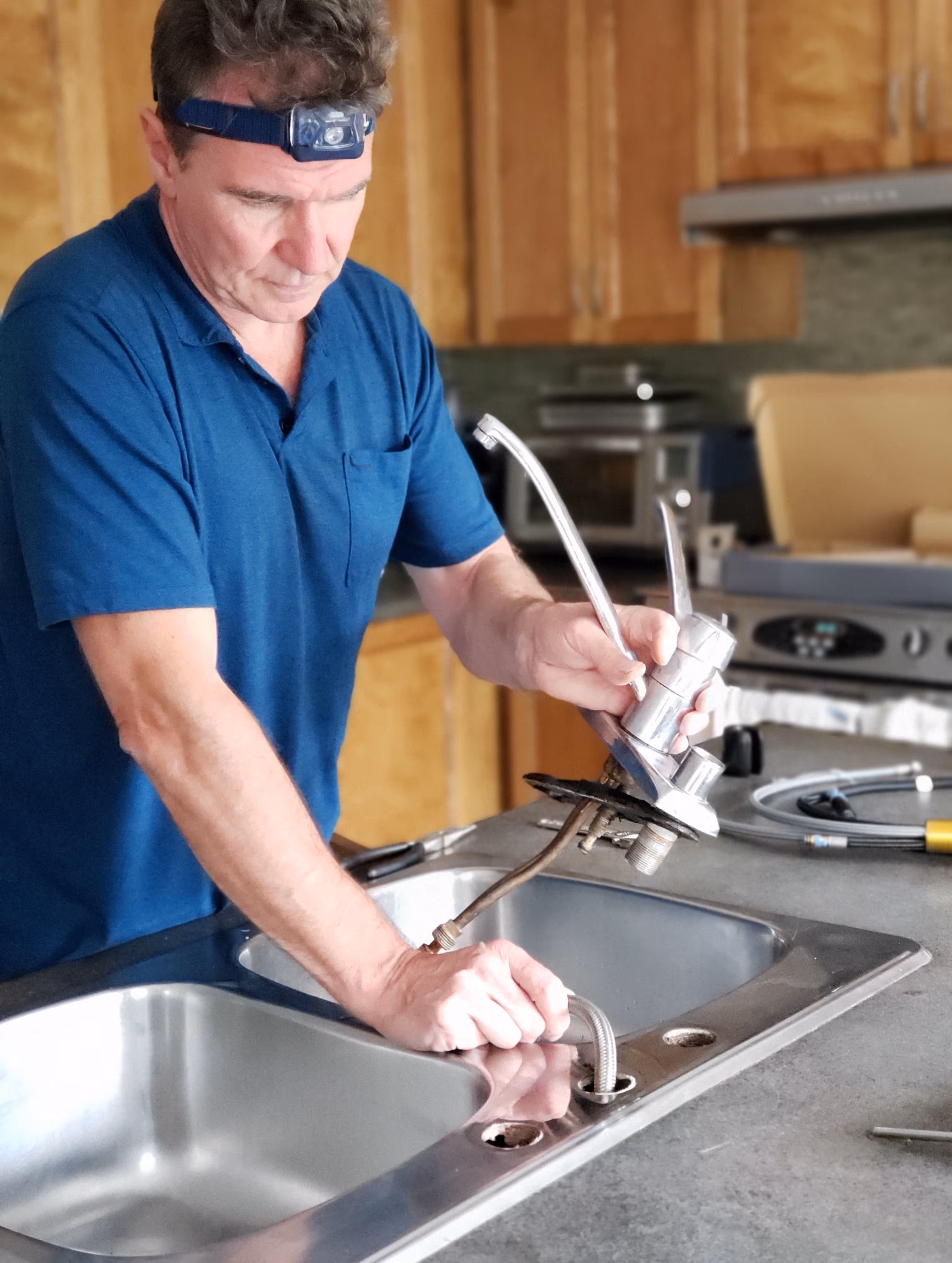 A plumber installing a sink.