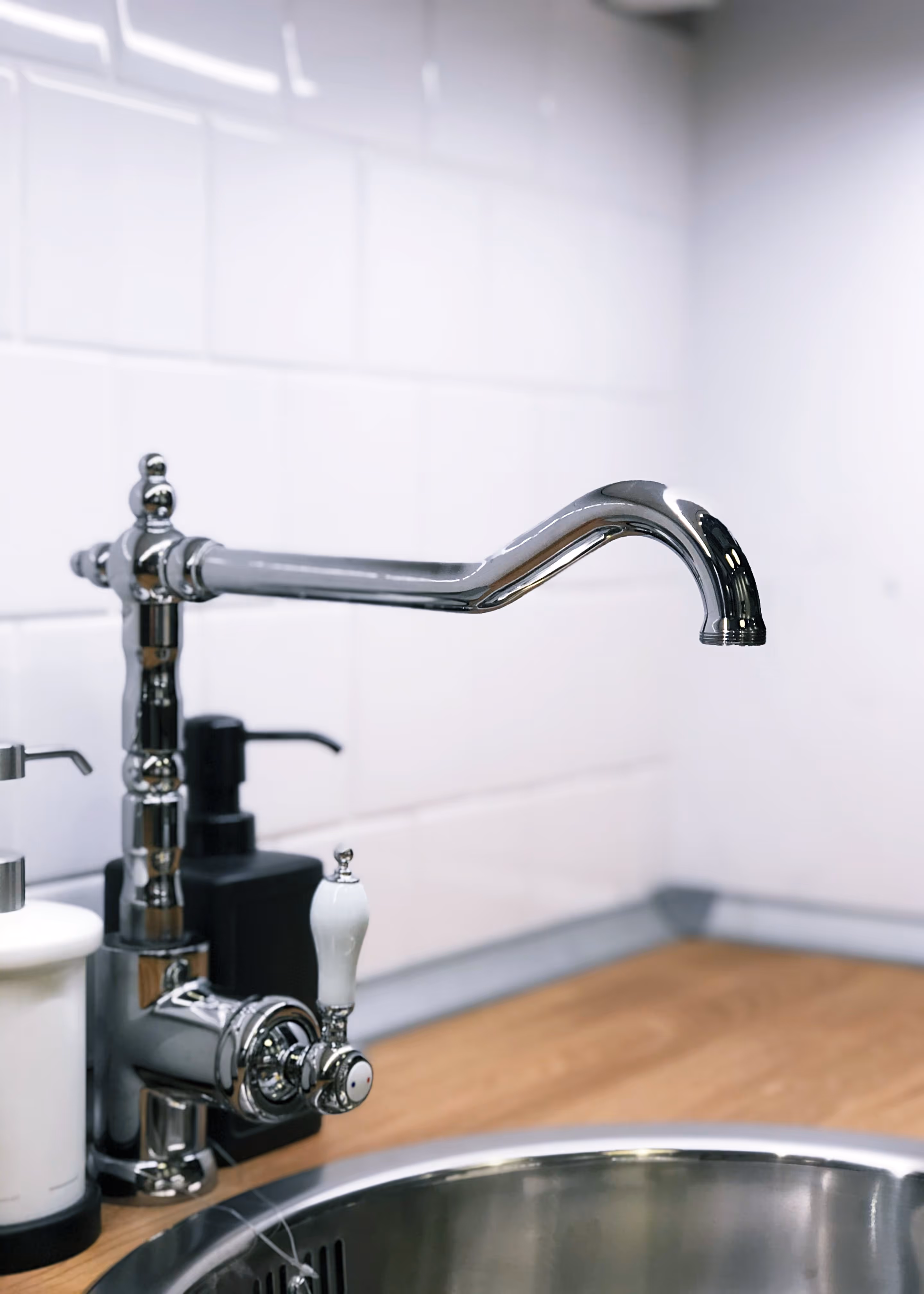 A sink with a wood counter.