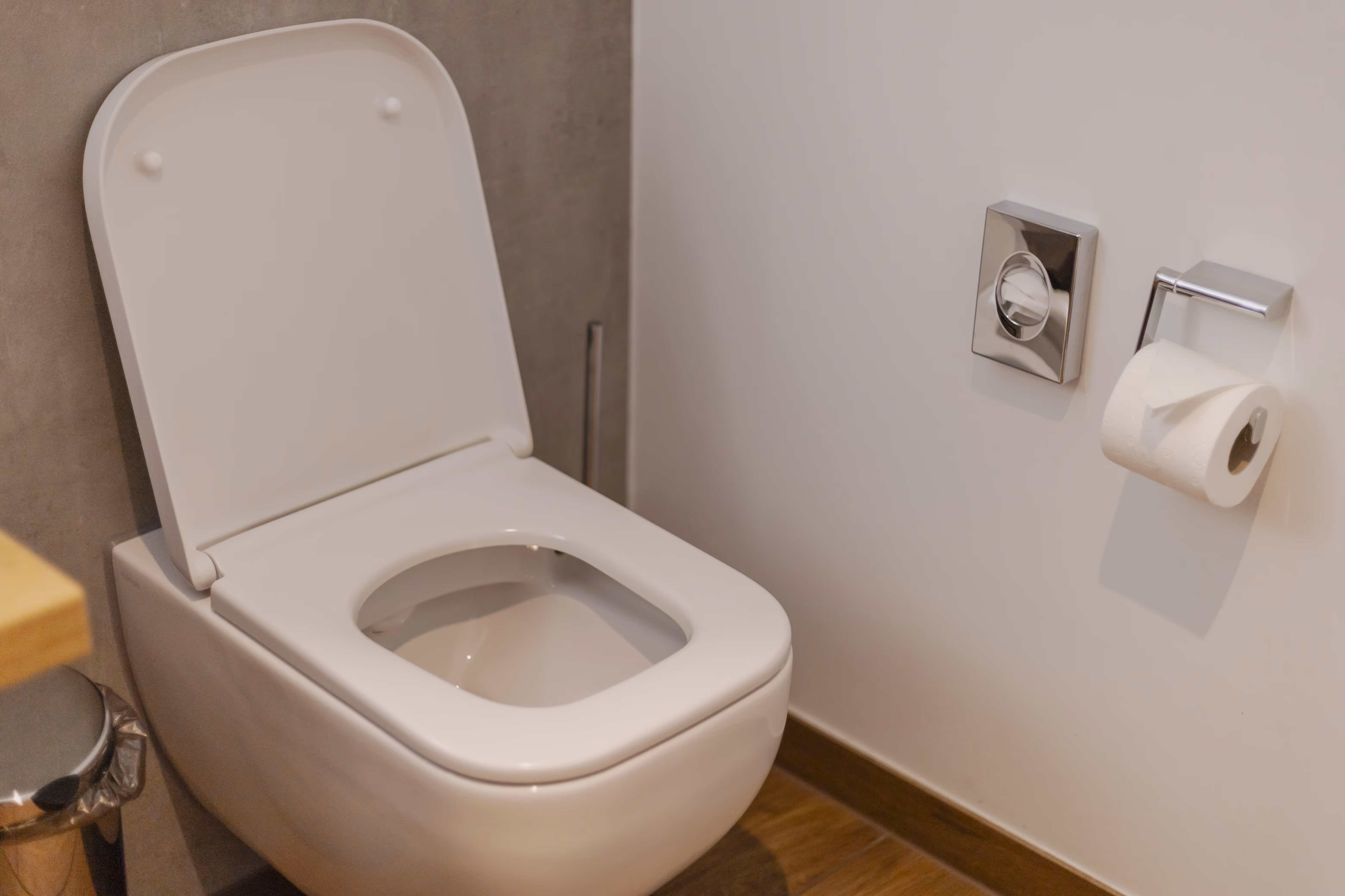 A toilet inside of a bathroom.