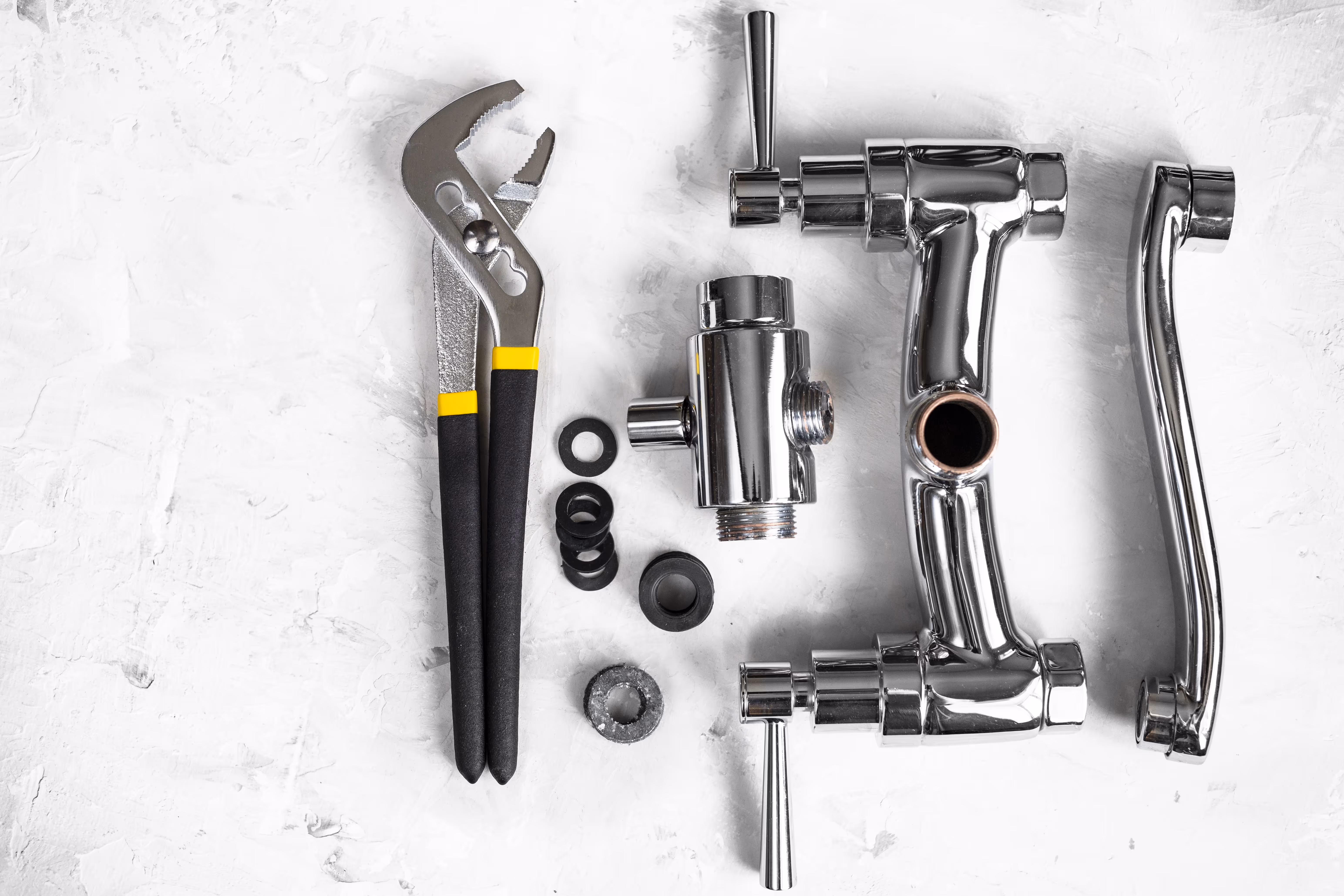 A wrench to the parts of a faucet spout.
