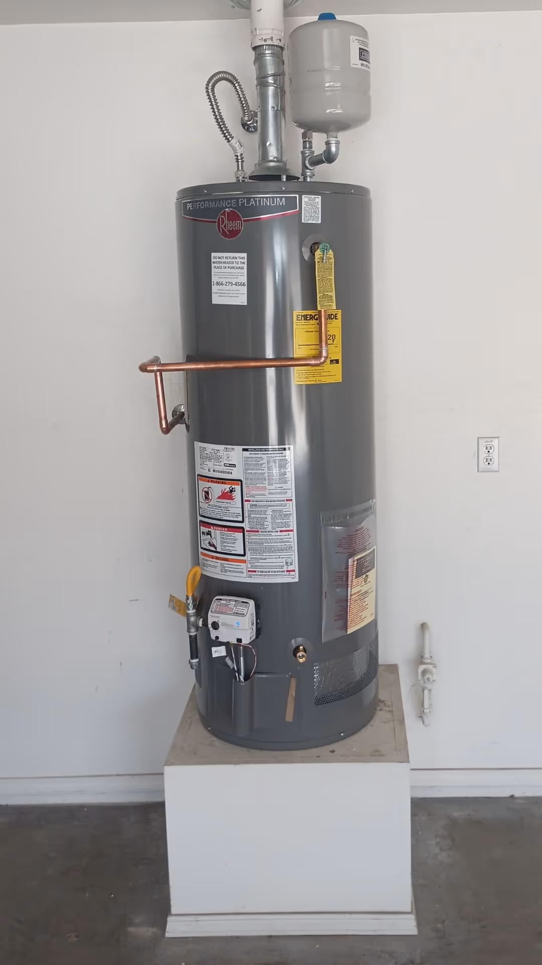 A water heater inside of garage.