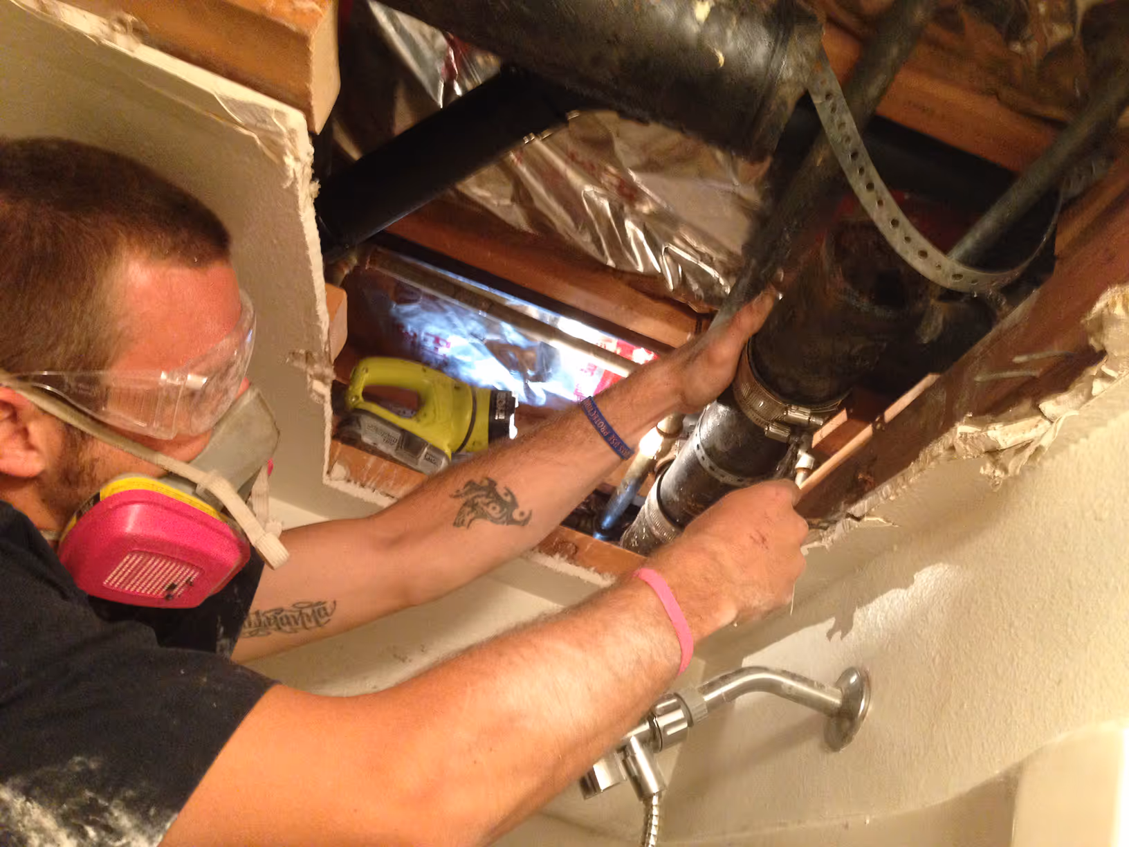 Plumber working on mobile home plumbing