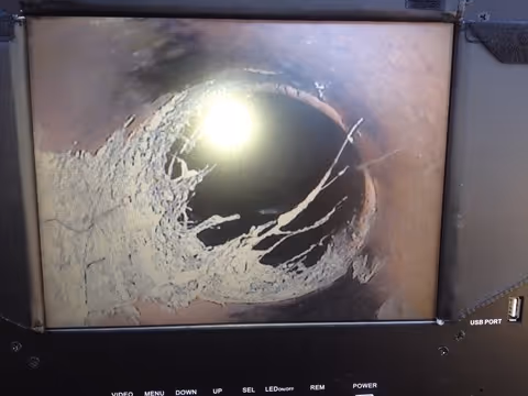Video camera inspection of a rooted sewer line, camera roots in the mainline