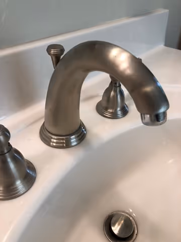 A bathroom faucet. leak, widespread faucet, faucet drips