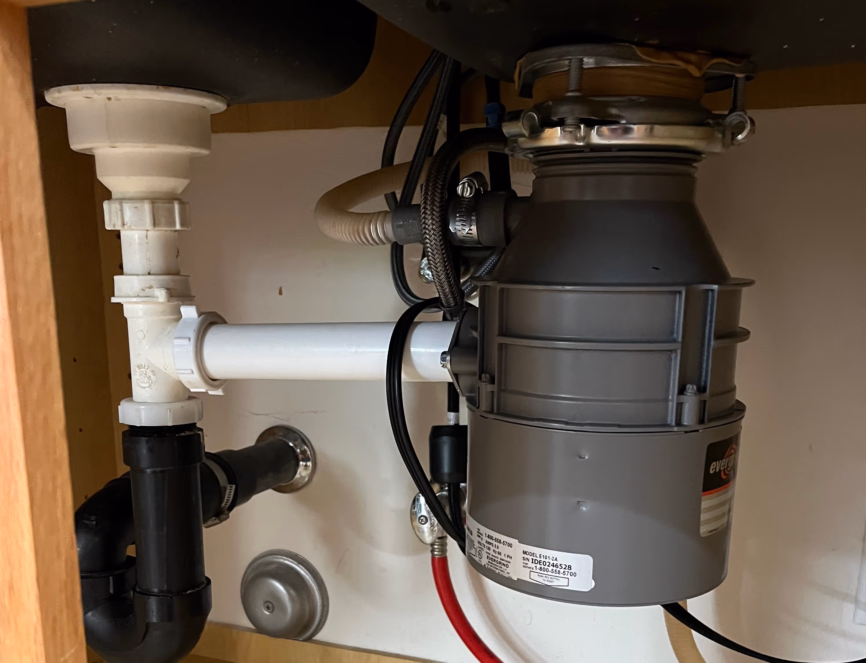 A garbage disposal underneath the kitchen sink