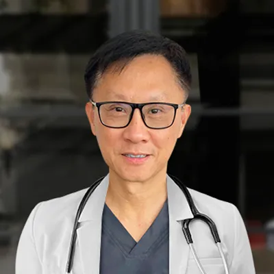 A male doctor smiling into the camera.