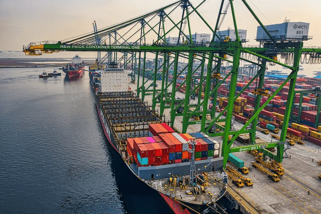 Image of a cargo ship in a port unloading goods