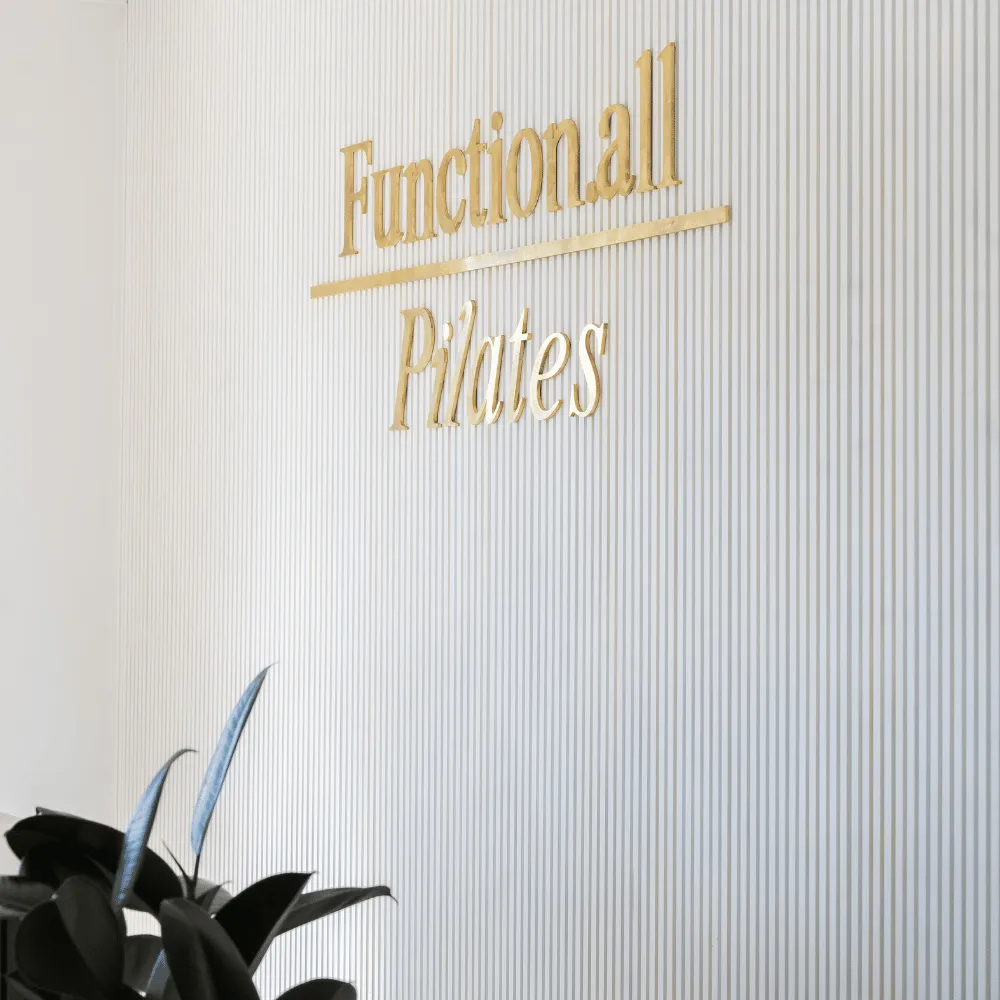 Gold Function.all Pilates sign on the studio wall