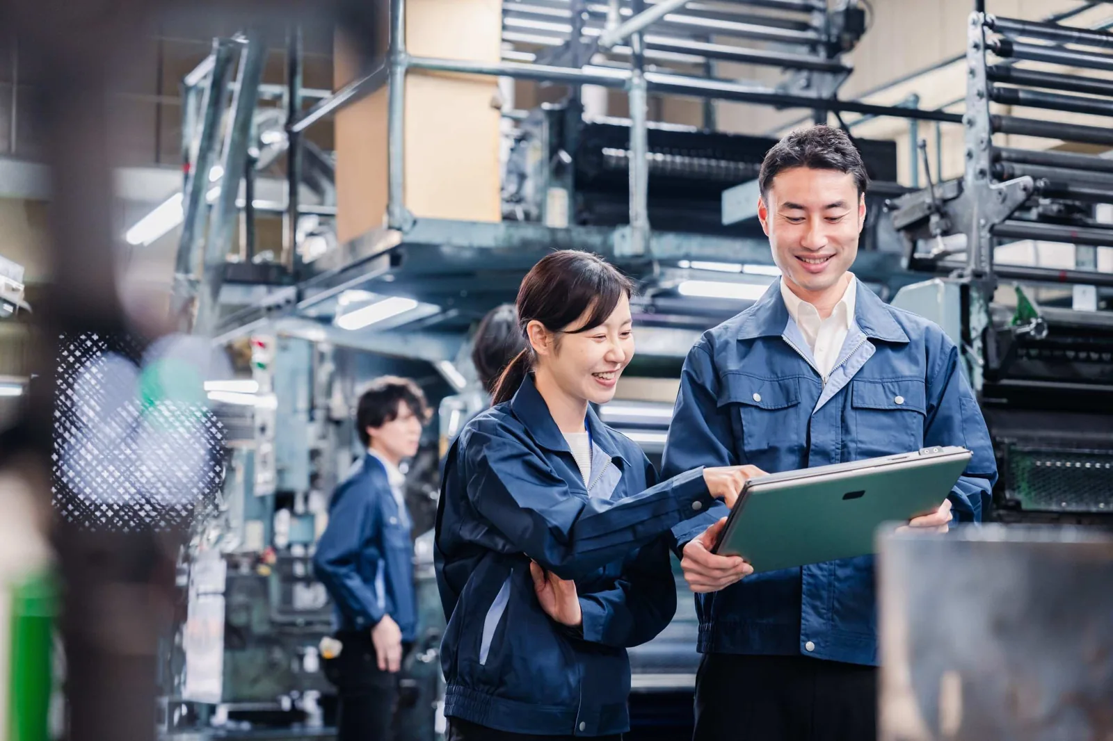 Factory managers discussing tablet.