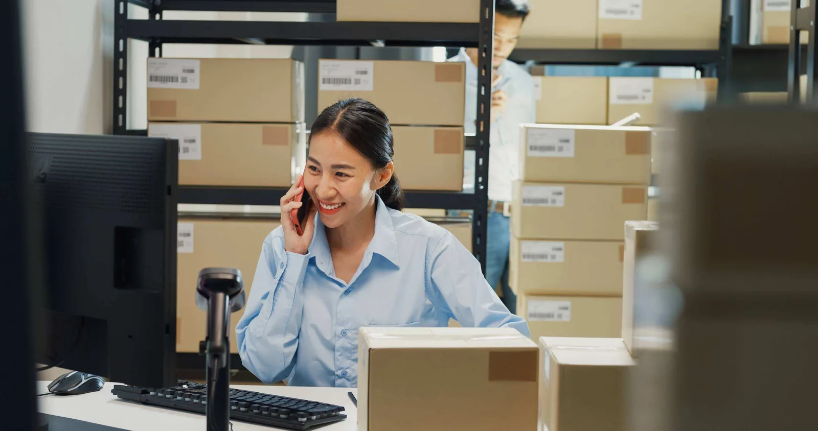 Warehouse worker on phone.