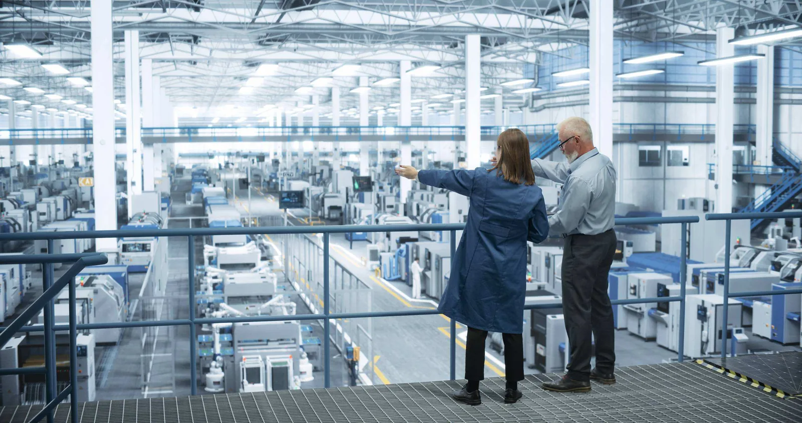 Factory managers discussing floor.