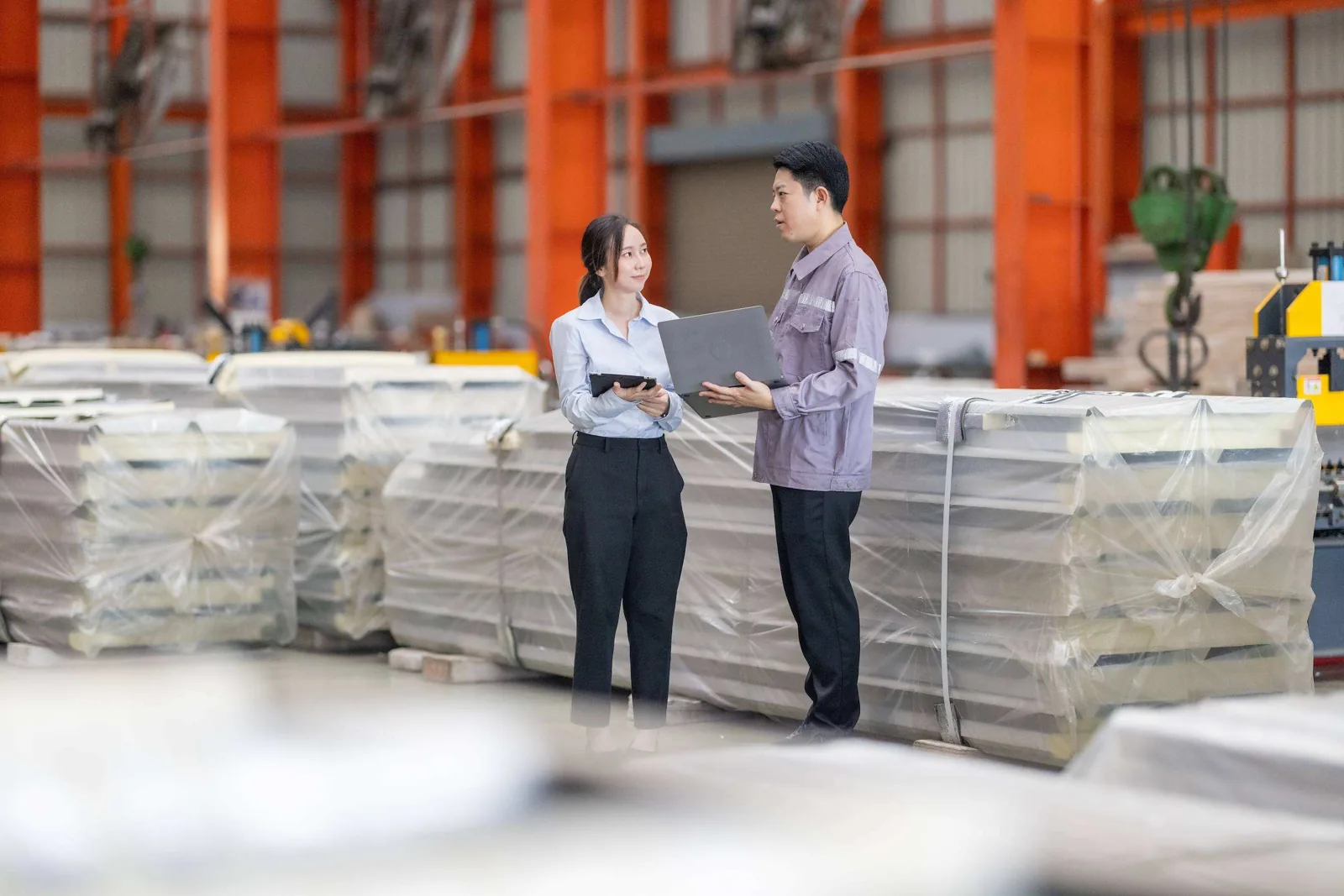 Factory workers discussing tablet.