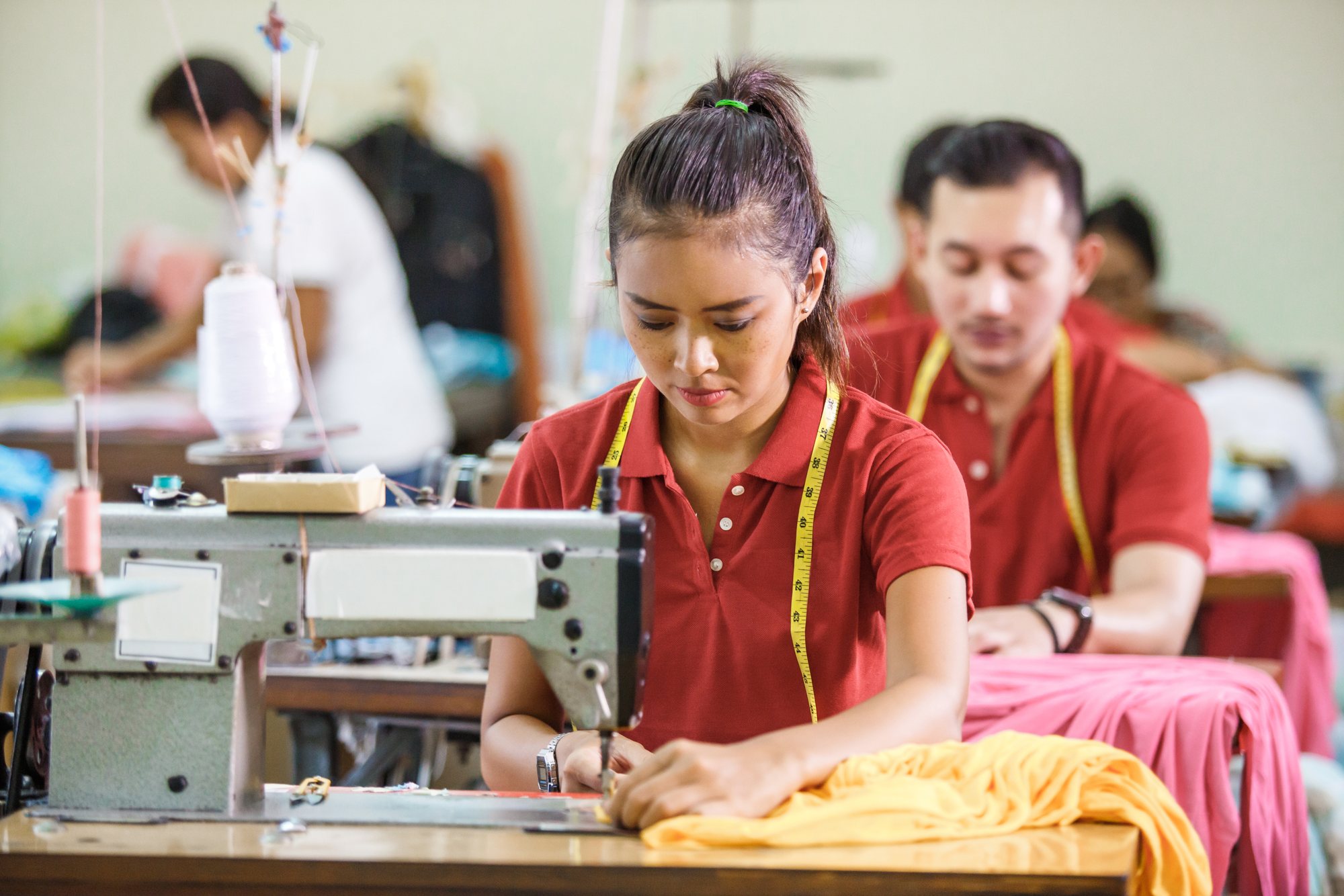 Workers sewing garments in production