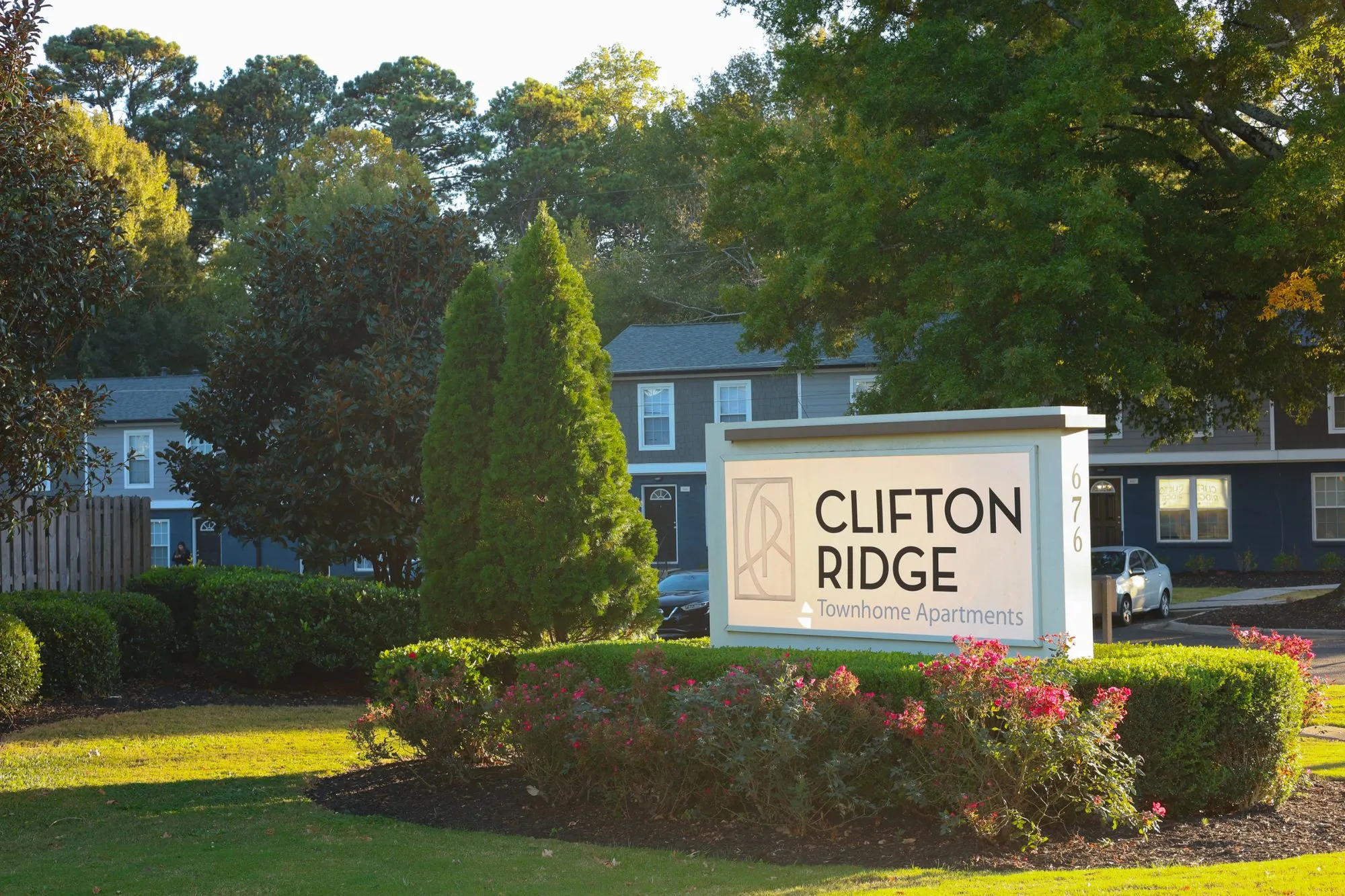 Community green space and stone monument sign at The Ridge Apartments in Marietta, GA