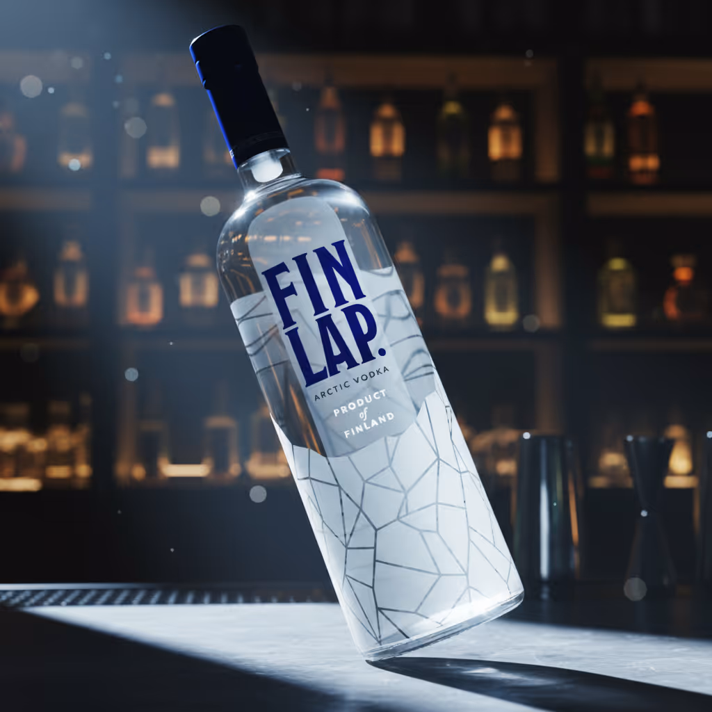 Bottle of Fin Lap Arctic Vodka with geometric design, tilted on a bar counter with blurred bottles in the background.