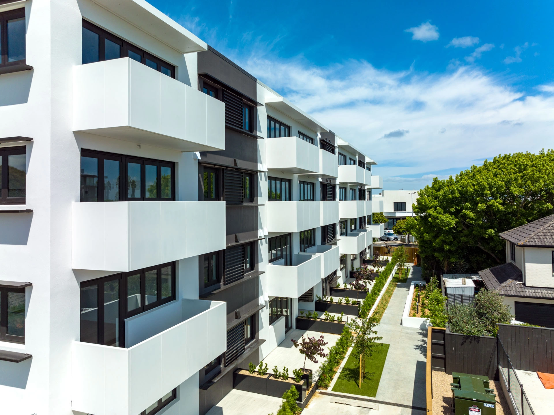 Belcanto Grappler Hook-On balconies with dark vertical balustrades on a residential development