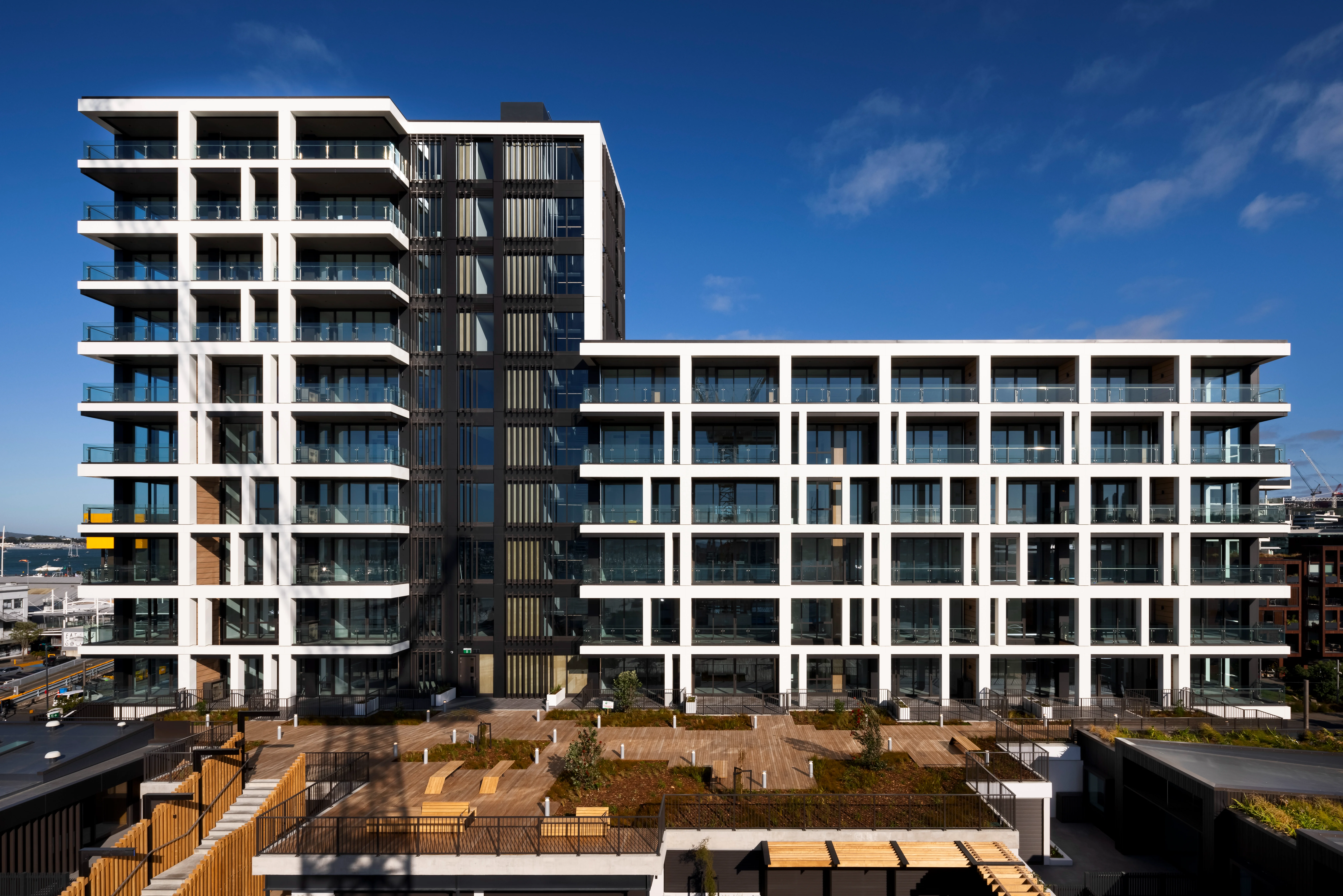 Wide view of the Belcanto residential building and landscaped terrace featuring Alliance Style Attache Balustrade.