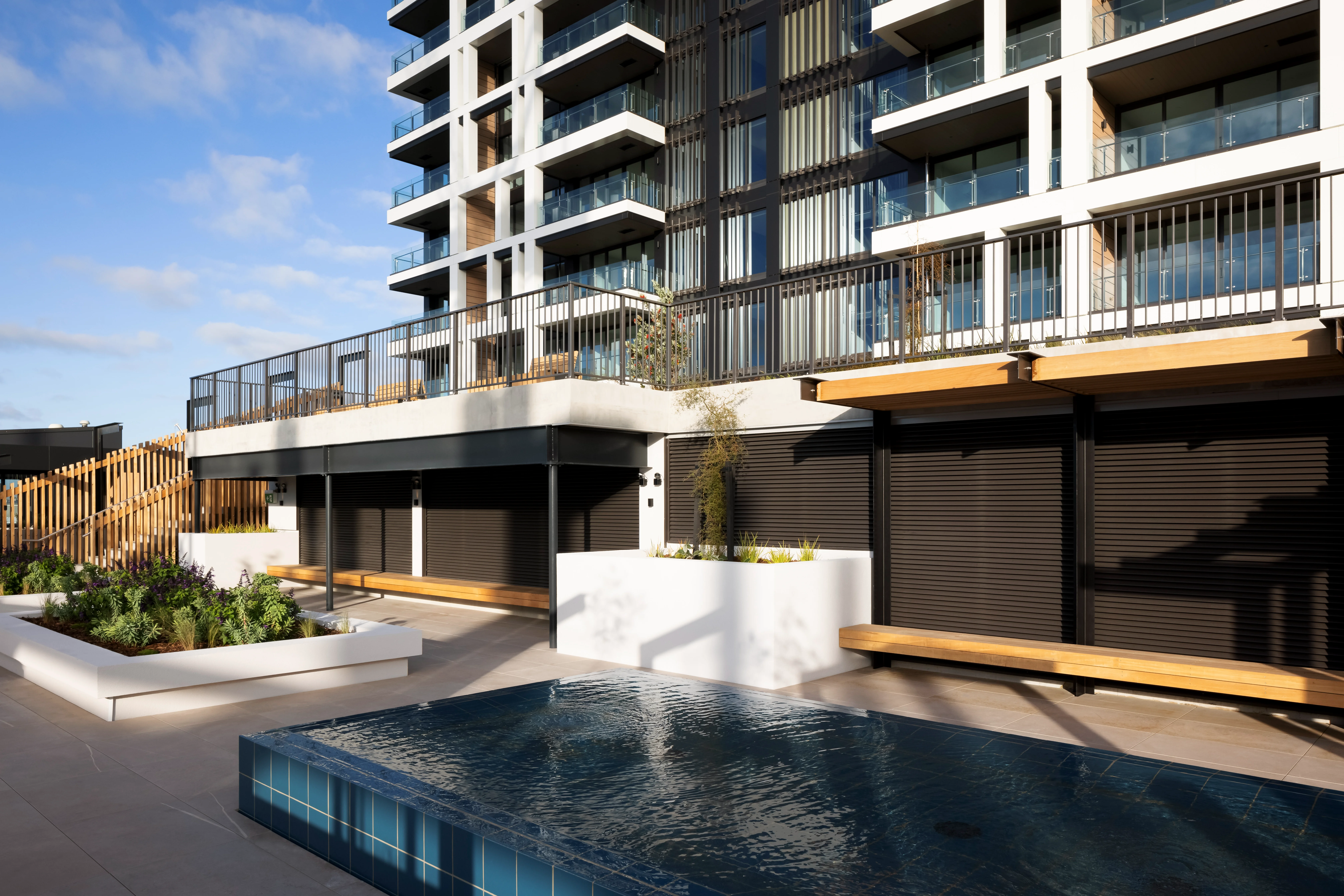 Water feature and landscaped terrace framed by black Attache Balustrade - Belcanto. in Alliance Style.
