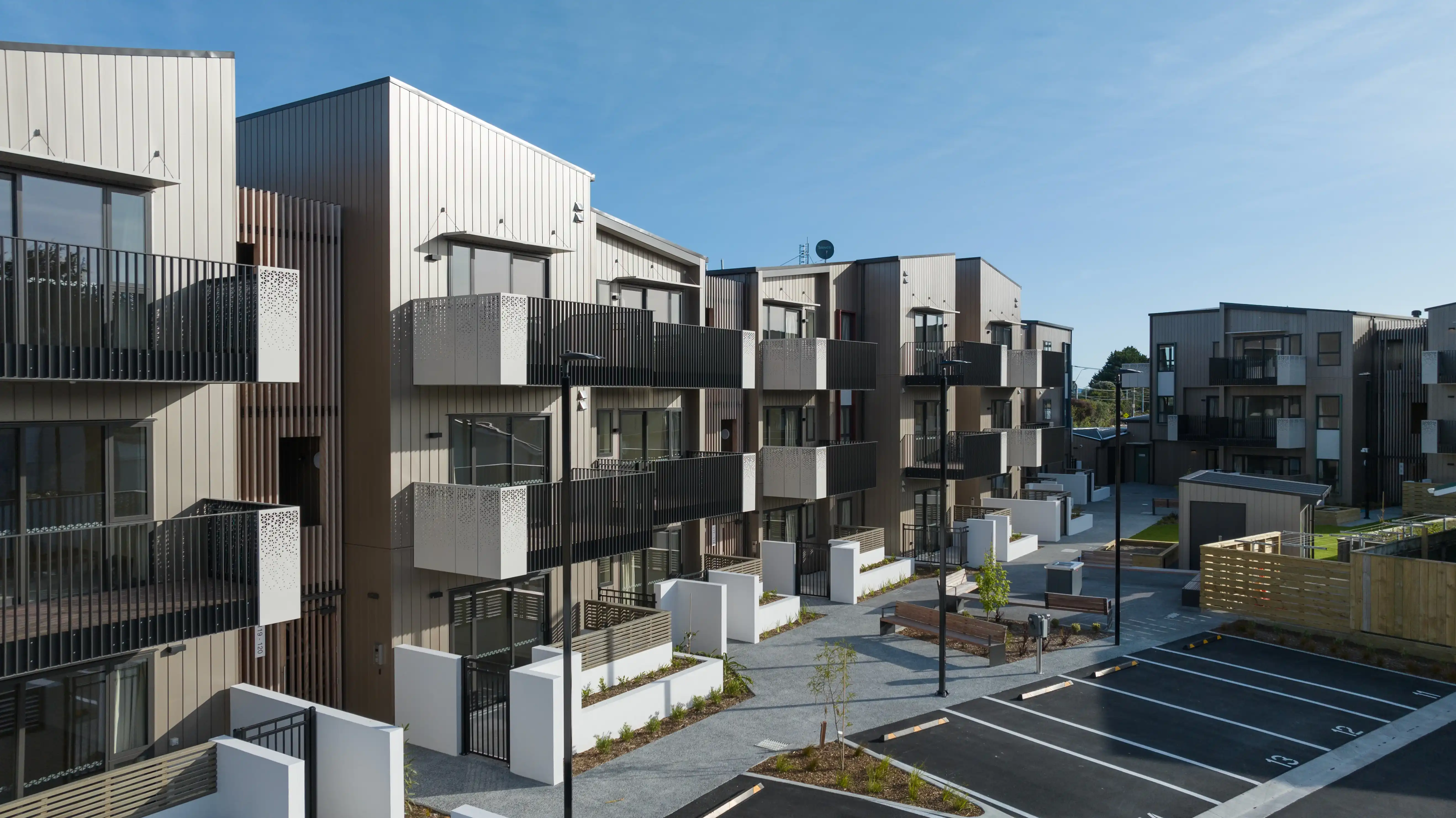 Oxford Terrace community housing in Lower Hutt, with Grappler balconies across three floors of one-bedroom apartments.