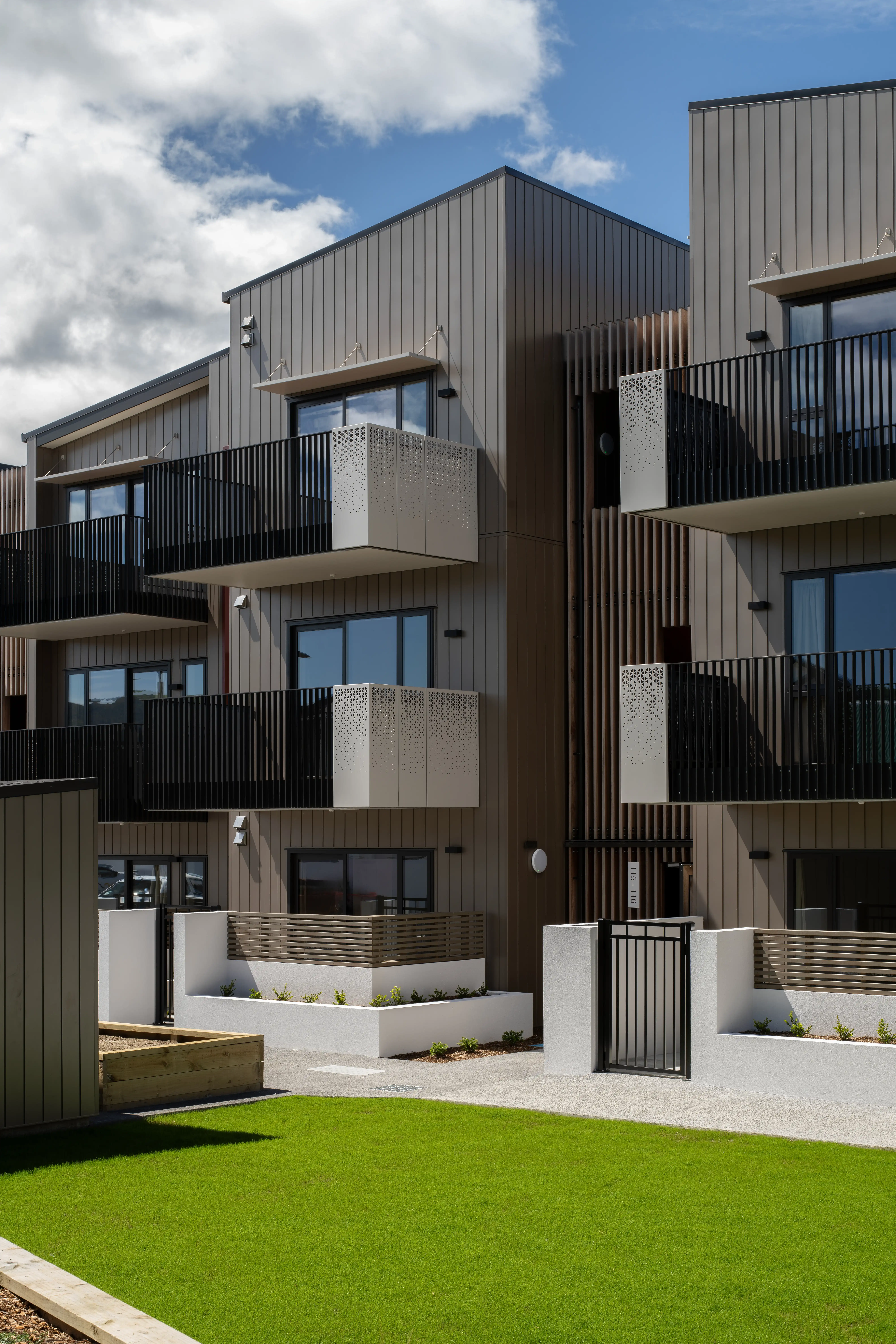 Kāinga Ora's Oxford Terrace apartments, where community housing balconies face the sun across a central outdoor area.